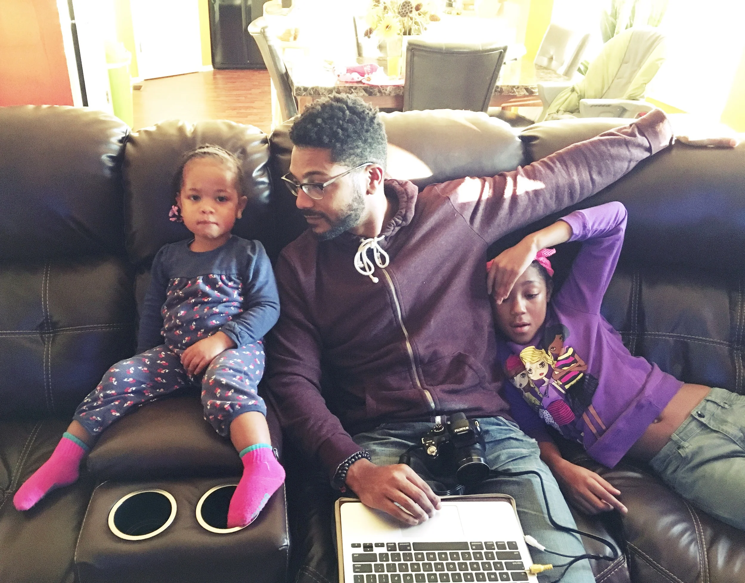 Daddy writing a paper but keeping his girls close.