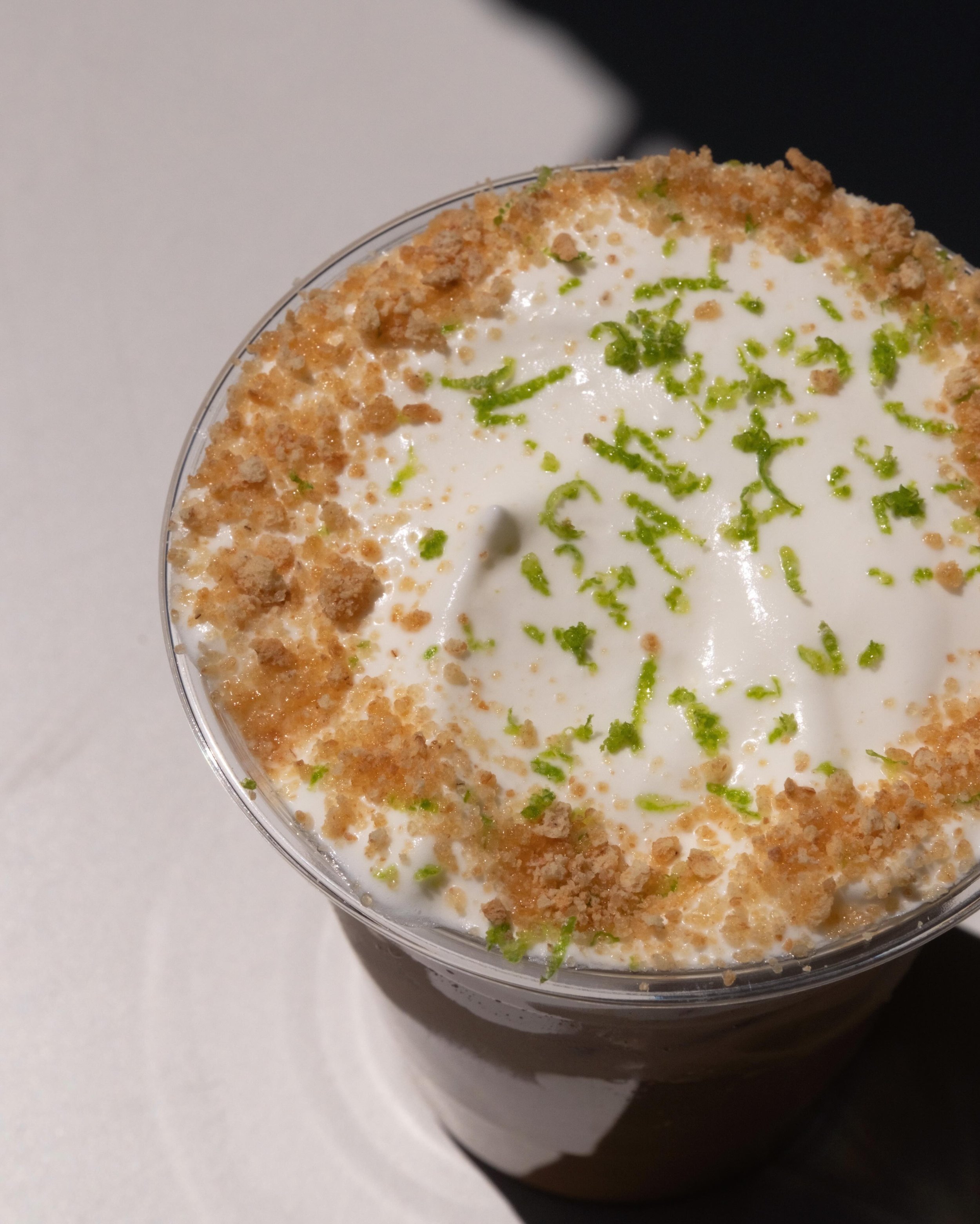 a summer menu favorite - iced graham cracker latte with key lime pie cold foam with graham cracker dust and lime zest. 🍋&zwj;🟩☀️🍋&zwj;🟩 // 📸 @wellbornartandphoto