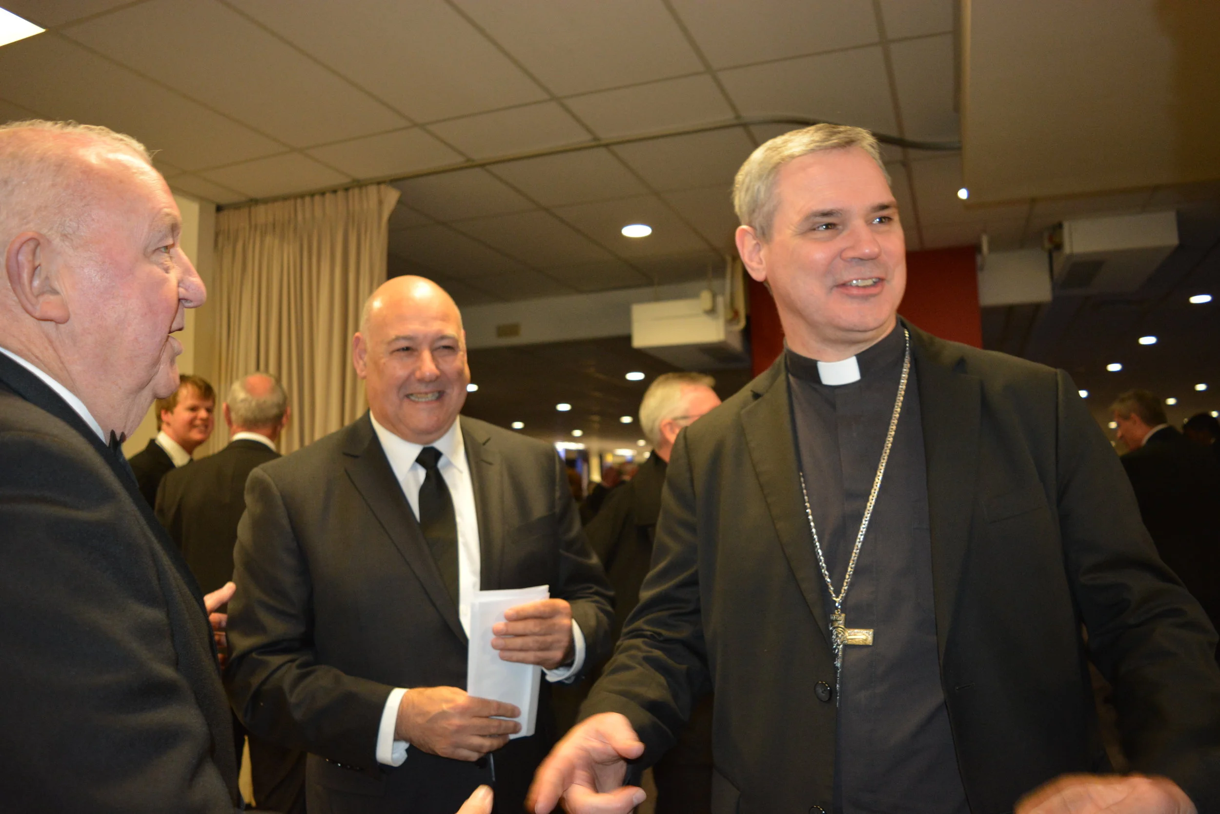 Archbishop Peter Comensoli is welcomed by Knights of the Southern Cross members.