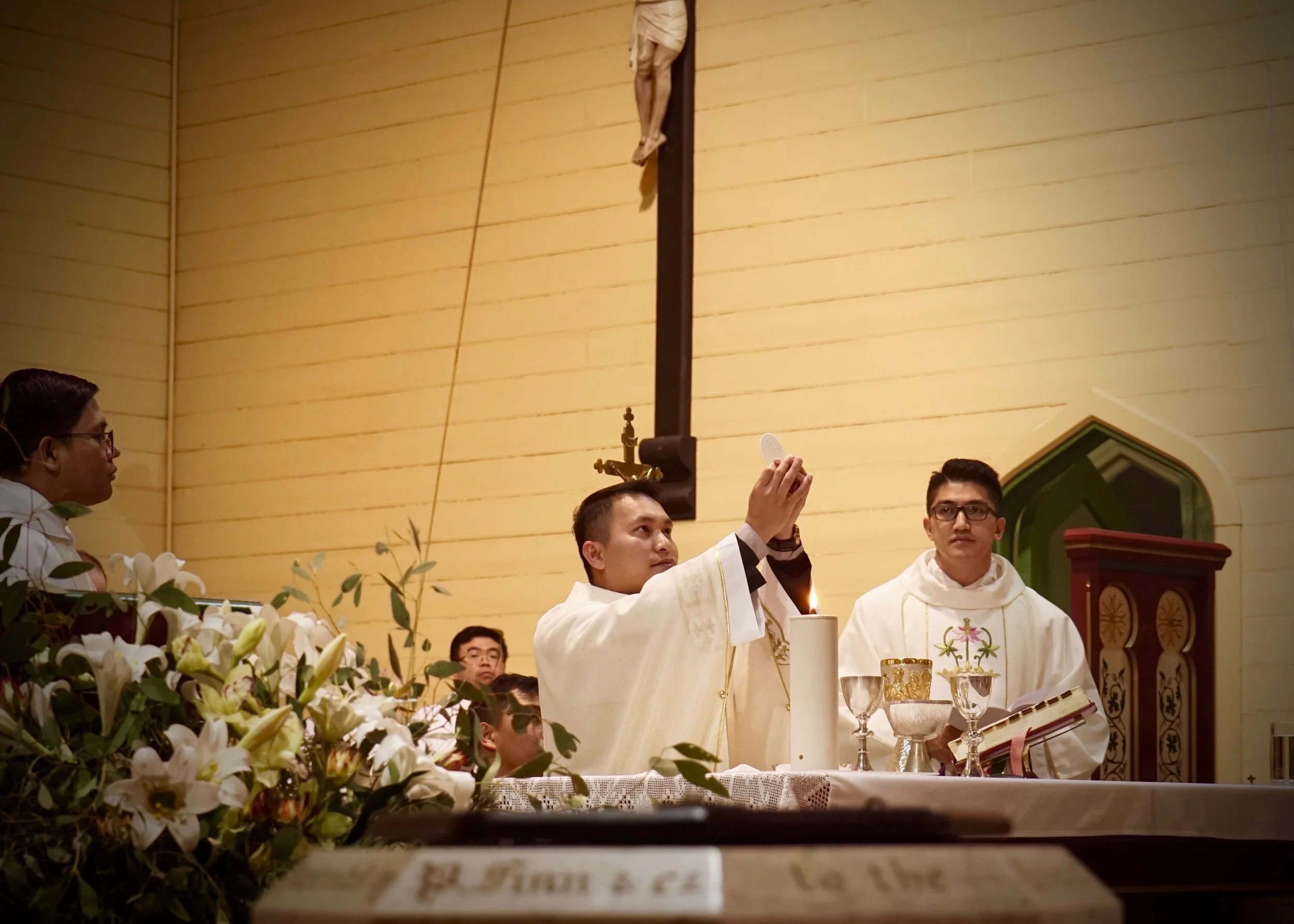 Fr Dean Bongat consecrates the bread into the Body of Christ during Mass for the first time.