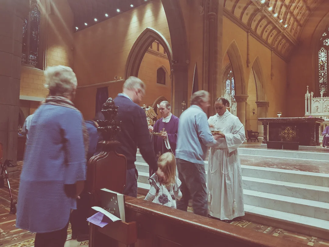 Matthew ministering Holy Communion with Bishop Paul Bird, Bishop of Ballarat.