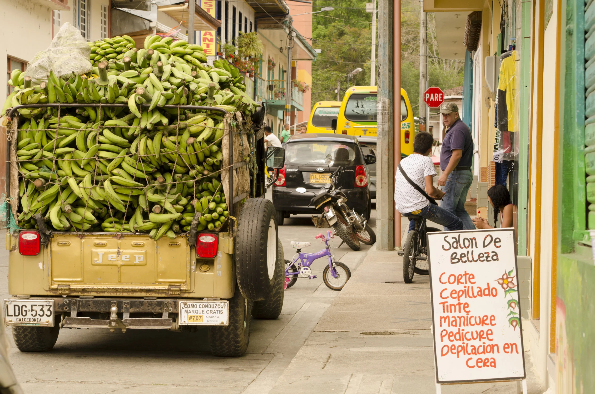 Typical street scene in a town near Hacienda Bambusa; WWII era Jeep Willy loaded to the brim with plantains.