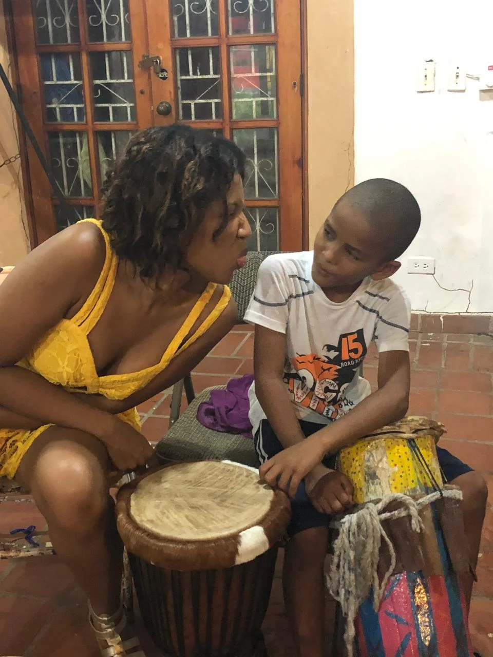 Diosamary Loré, Director of Sales at El Otro Lado, clowns around with Elian 8-year old student at the Little Rhythm School which provides local kids with free musical classes with support of the Bahia Portobelo Foundation.