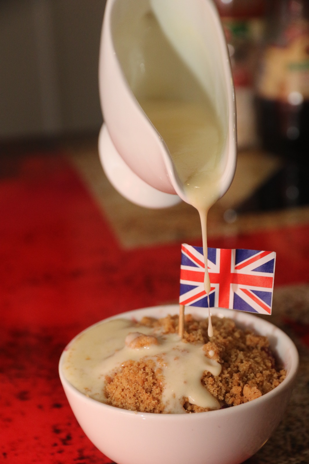 Pouring custard on apple crumble.jpg
