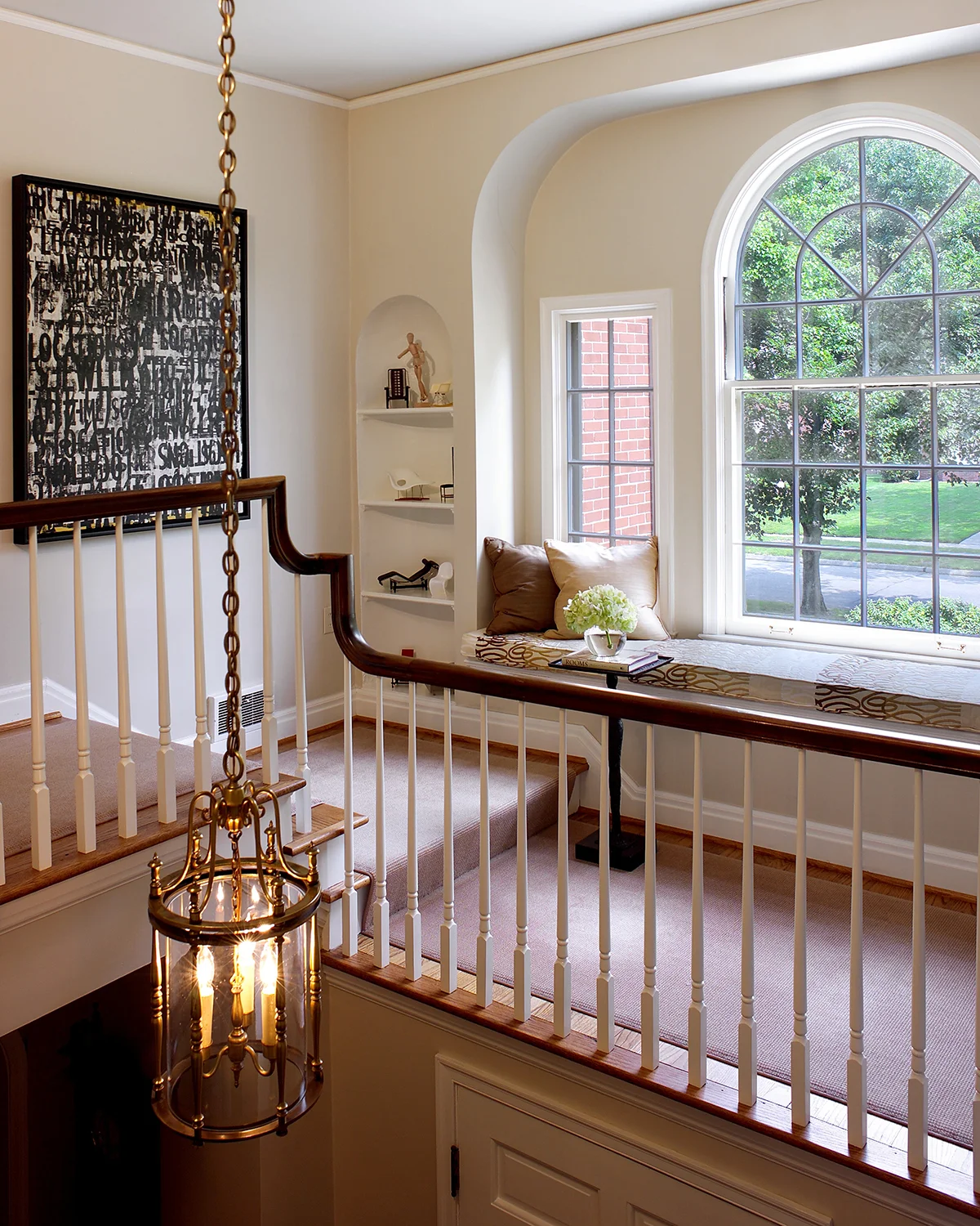 This is no ordinary landing; it’s practically another room! Because the home’s traditional architecture is so clean and simple, we were able to contrast it with contemporary fabrics and artwork. Our client’s miniature chairs fit perfectly in the niche—a collection always has more impact when grouped together. We covered the window seat in a graphic Italian fabric, and added a bronze spot table to hold a book or glass of wine. Contemporary graffiti artwork completes the space. We’re told it’s a favorite place to sit, read, and watch the world go by. Photo by Gene Meadows.