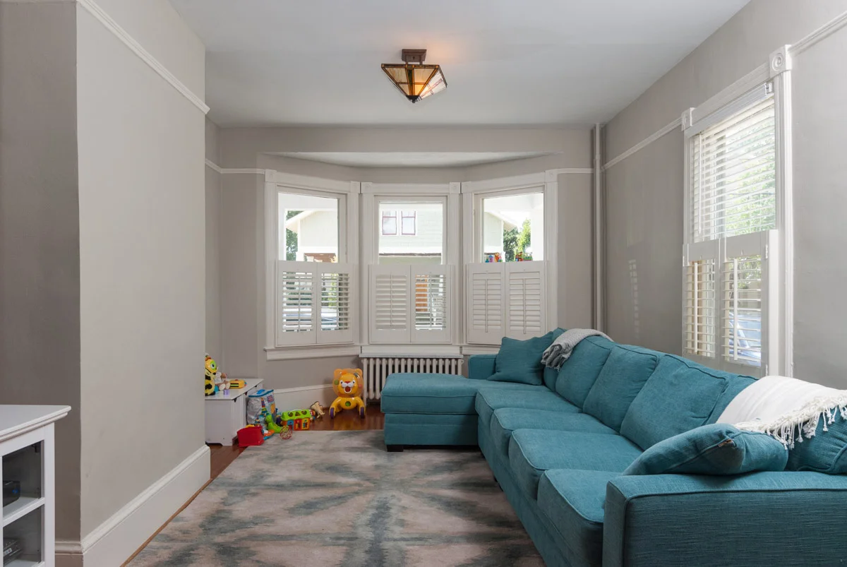 An unstaged living room. Try not to trip on any toys.