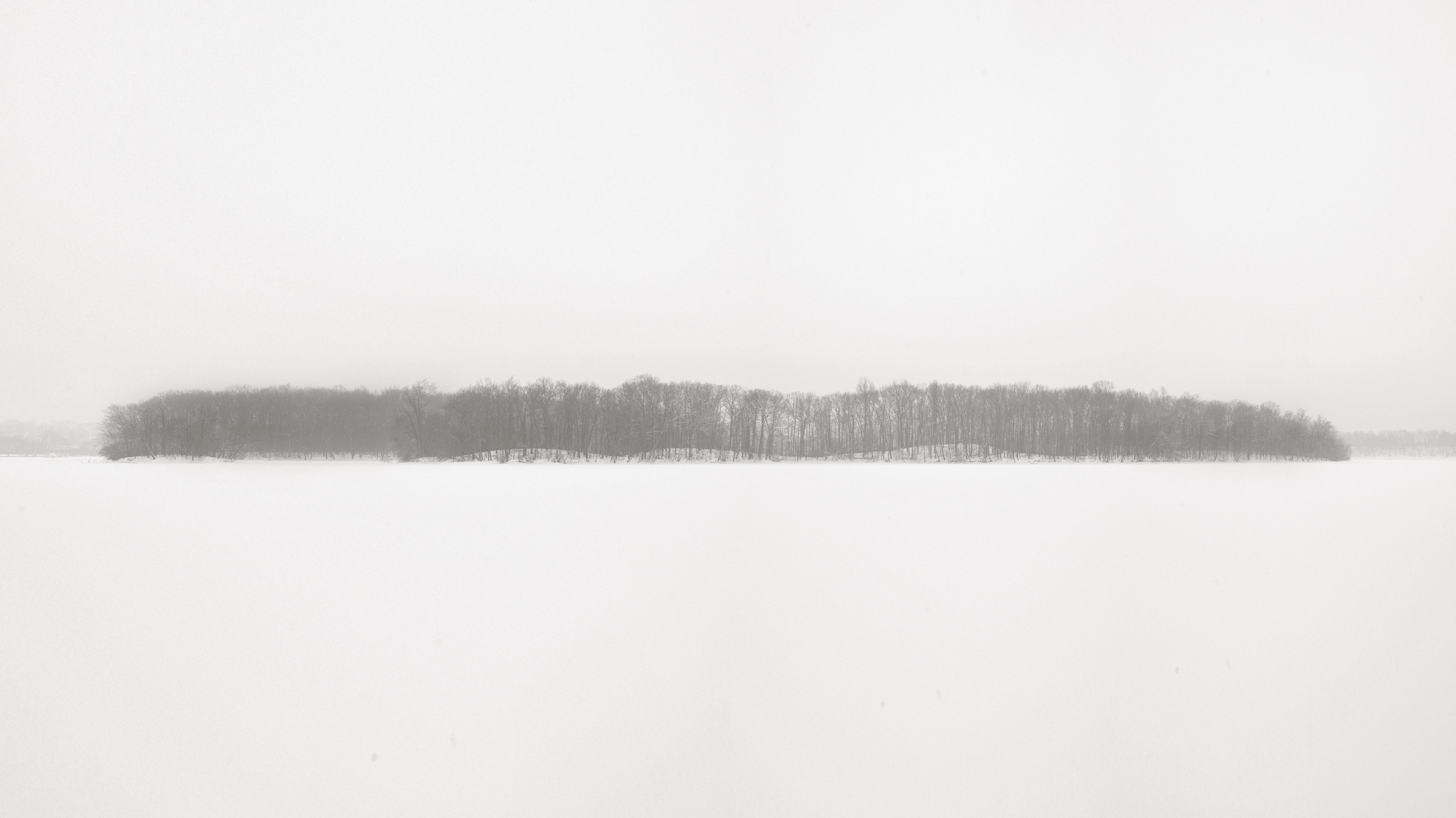 Island on Kent Lake from Turtlehead Point. Eight inches had already fallen overnight and the morning promised a few more. Snow was falling hard while I took this photo. Michigan Landscape Photography.