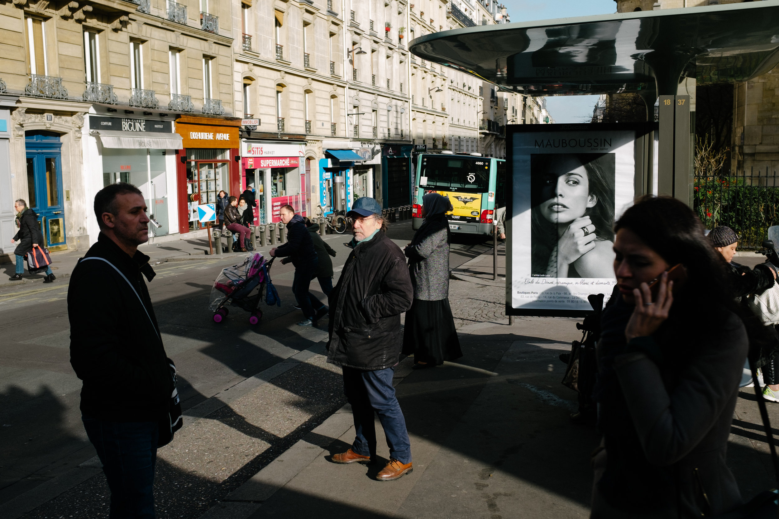 Each character in the frame is doing something different and filling empty spaces in the foreground, middleground and background. Photo by William Lounsbury.