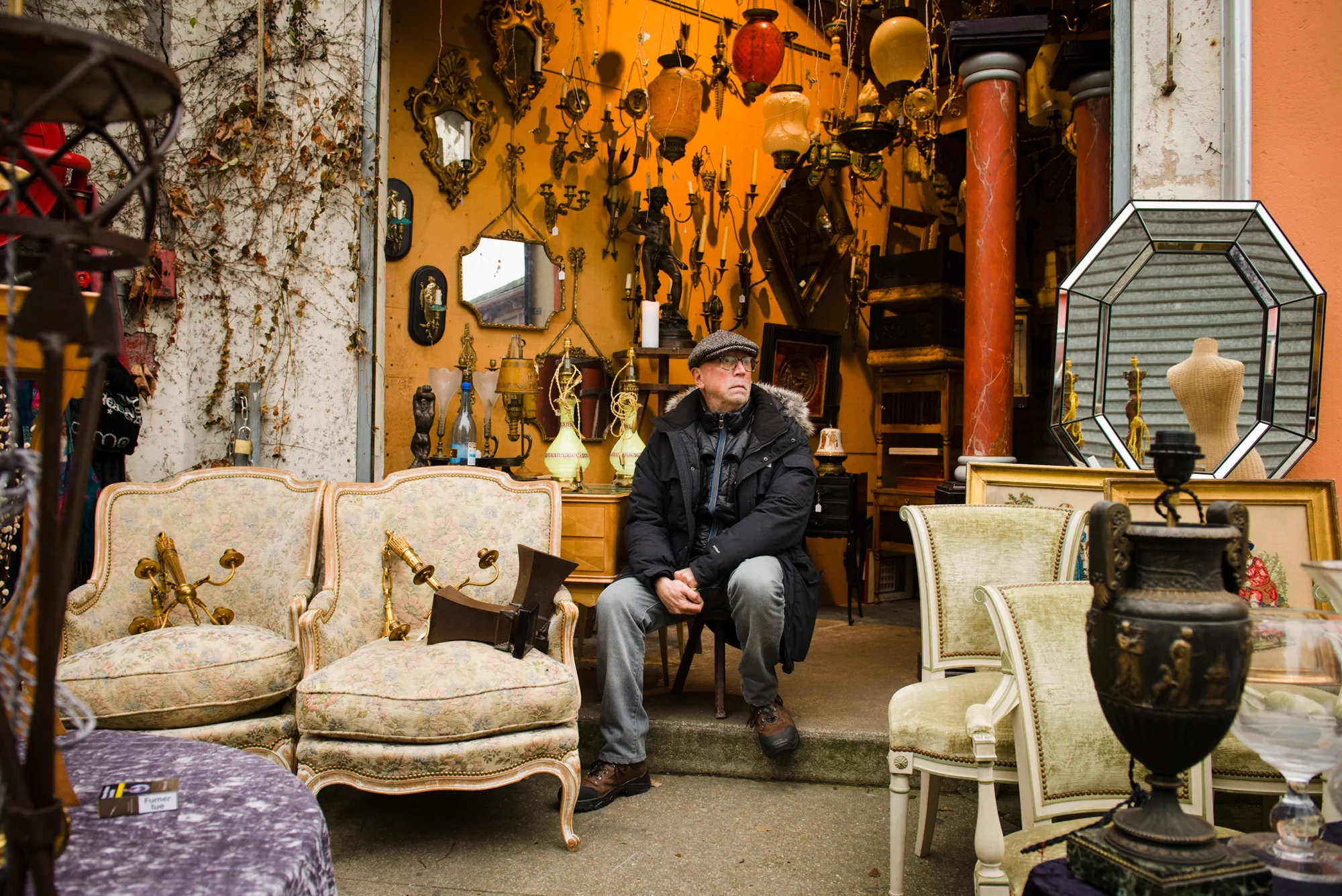Claude Lenati, Marché Paul Bert - Allée 1, Stand 23 For 27 years Claude has had a stand in the Marché Paul Bert. Claude does not specialize in specific antiques, but rather sells an assortment of many things. “I am not an antiquer, but a brocanteur,” said Claude. “people like me will all be gone in 20 years, the brocanteurs are being replaced by gallerists; people in their 20s and 30s.” PHOTOGRAPHY: William Lounsbury • Nikon D800 • AF-S NIKKOR 24-70mm Ƒ/2.8G ED @ 27MM • Ƒ/5 • 1/60 • ISO 400