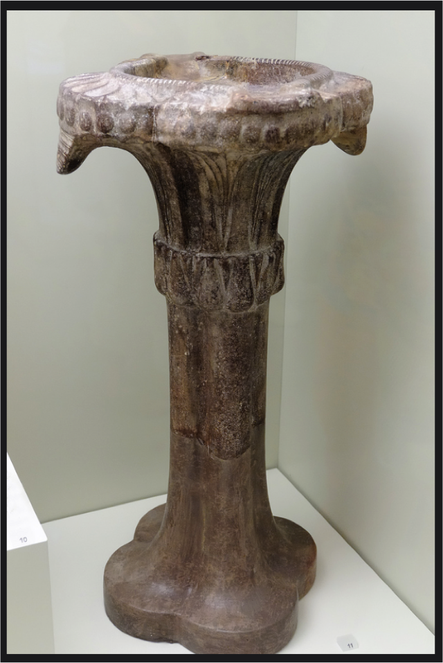 One of the treasures of the Heraklion Museum, on the north shore of Crete is this Columnar Lamp. The discovery and cultivation of the olive played a significant role in the emergence of the Aegean World in the Middle Bronze Age. One of its primary objects of trade was olive oil, a marvelously versatile product. One of its indispensable roles was providing light. This lamp, in its columnar form and capital, directly calls to mind one distinct type of Ancient Egyptian Plant-Form Column. Note how it both emphatically stands, yet soars, while it gently cradles its basin of oil for its glowing overhanging wicks. It would appear that the capital is comprised of overhanging palm fronds. 