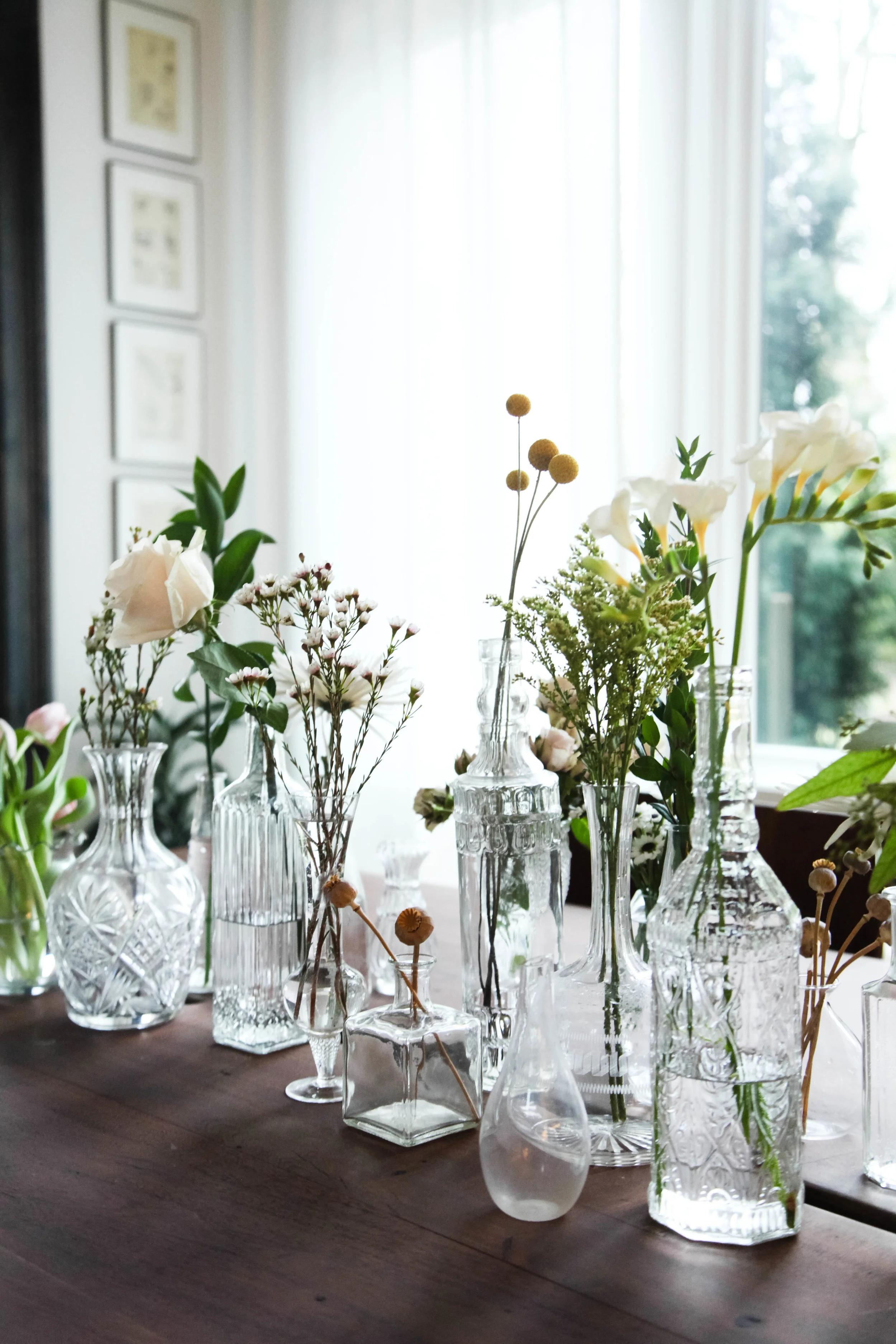 Style tip: Display collection of glass vases and bottles on a dining table. Place flowers into them. The natural light reflecting the glass is so pretty!