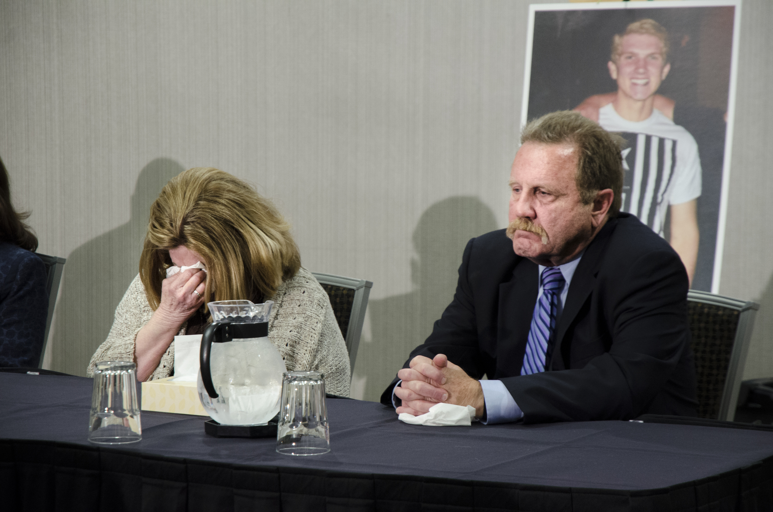   Gina McMillan-Weese sits next to Ryan’s father Walter McMillan as she covers her face and cries during the news conference held by their attorneys on February 23, 2016 in Denton, Texas.  