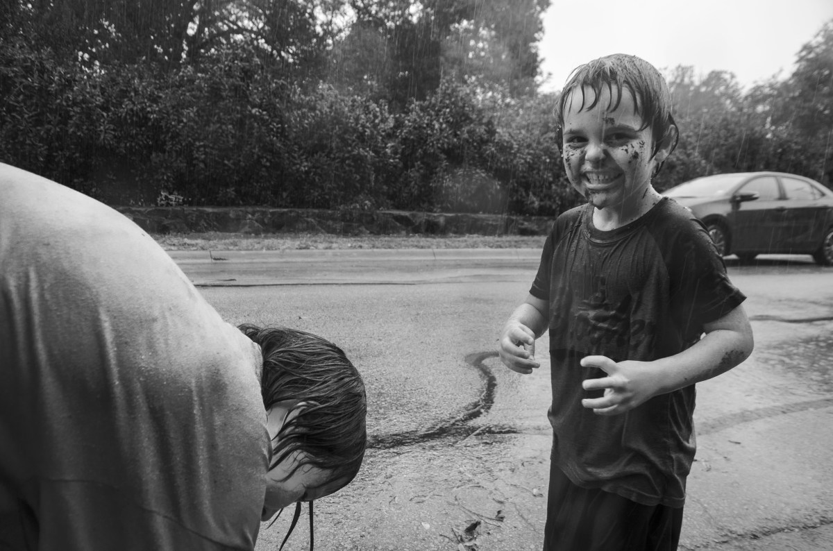 Two children play in the North Texas rain.