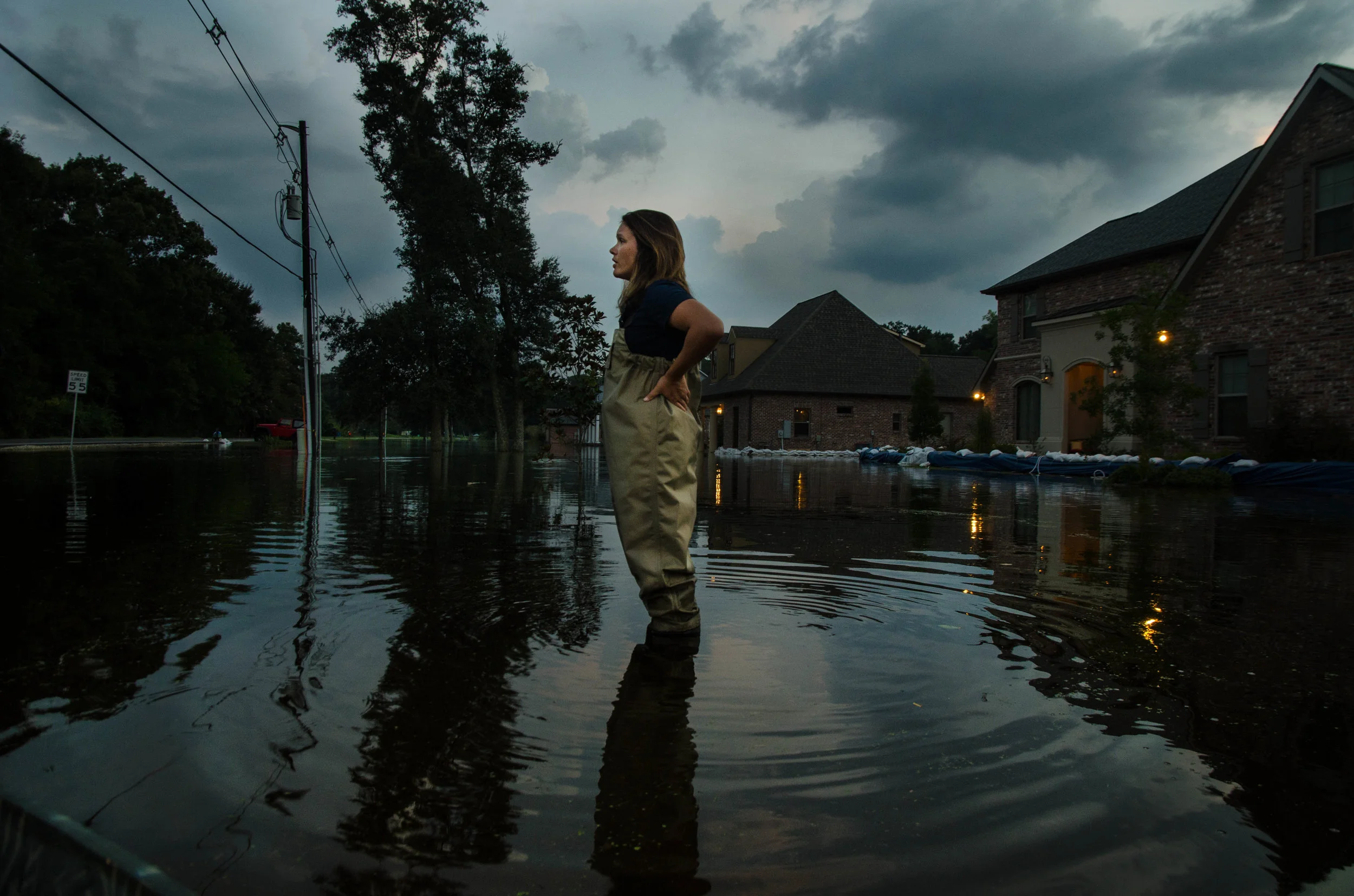 Glenda Mora, a homeowner on Bluff Rd in Baton Rouge, Louisiana, looks out over the neighborhood.