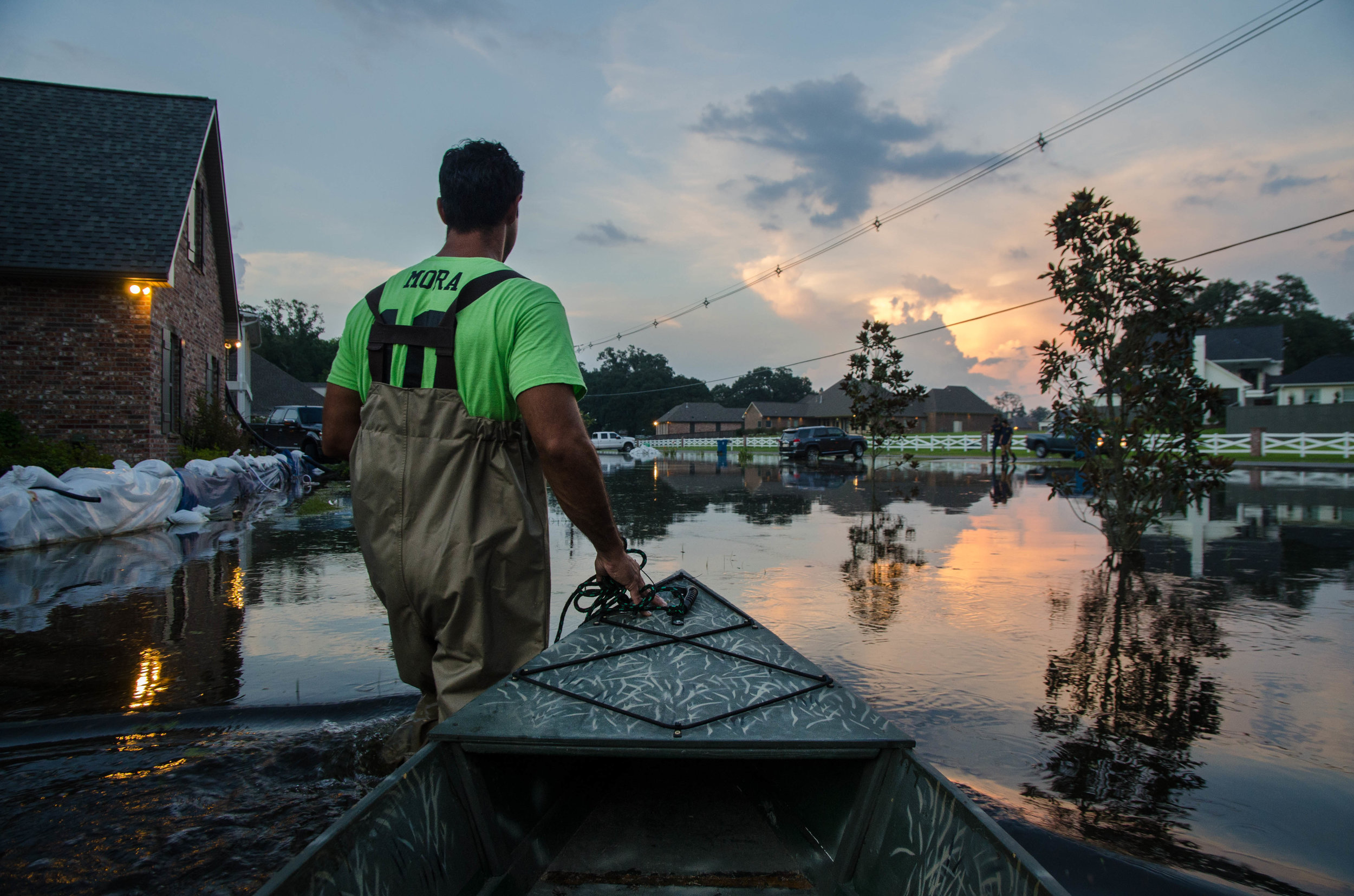  Blake Mora checks on the sand bags protecting his house on Bluff Rd in Baton Rouge, Louisiana. 