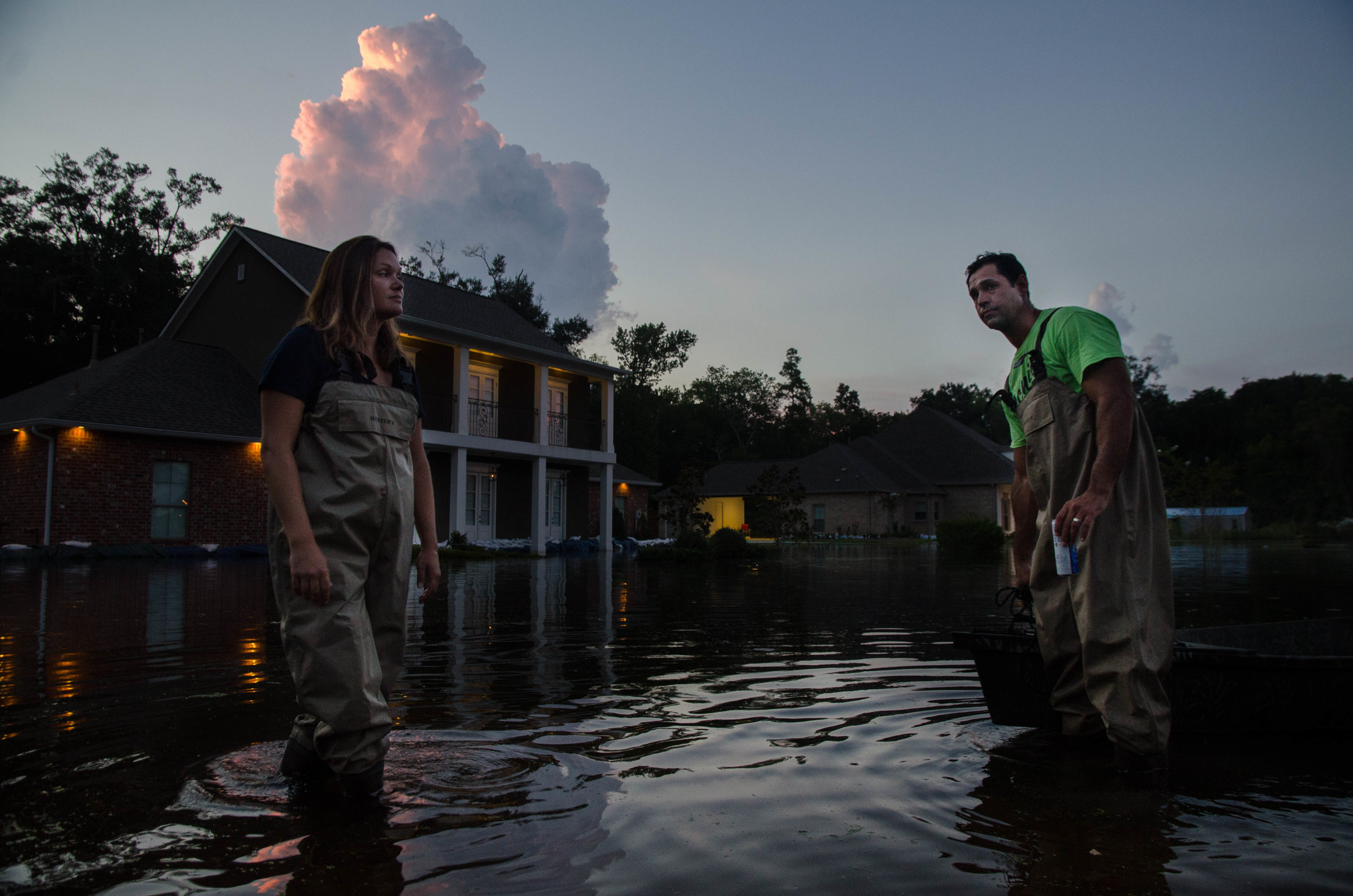  Glenda Mora and Blake Mora stand in the front yard of their home on Bluff Rd in Baton Rouge, Louisiana. 