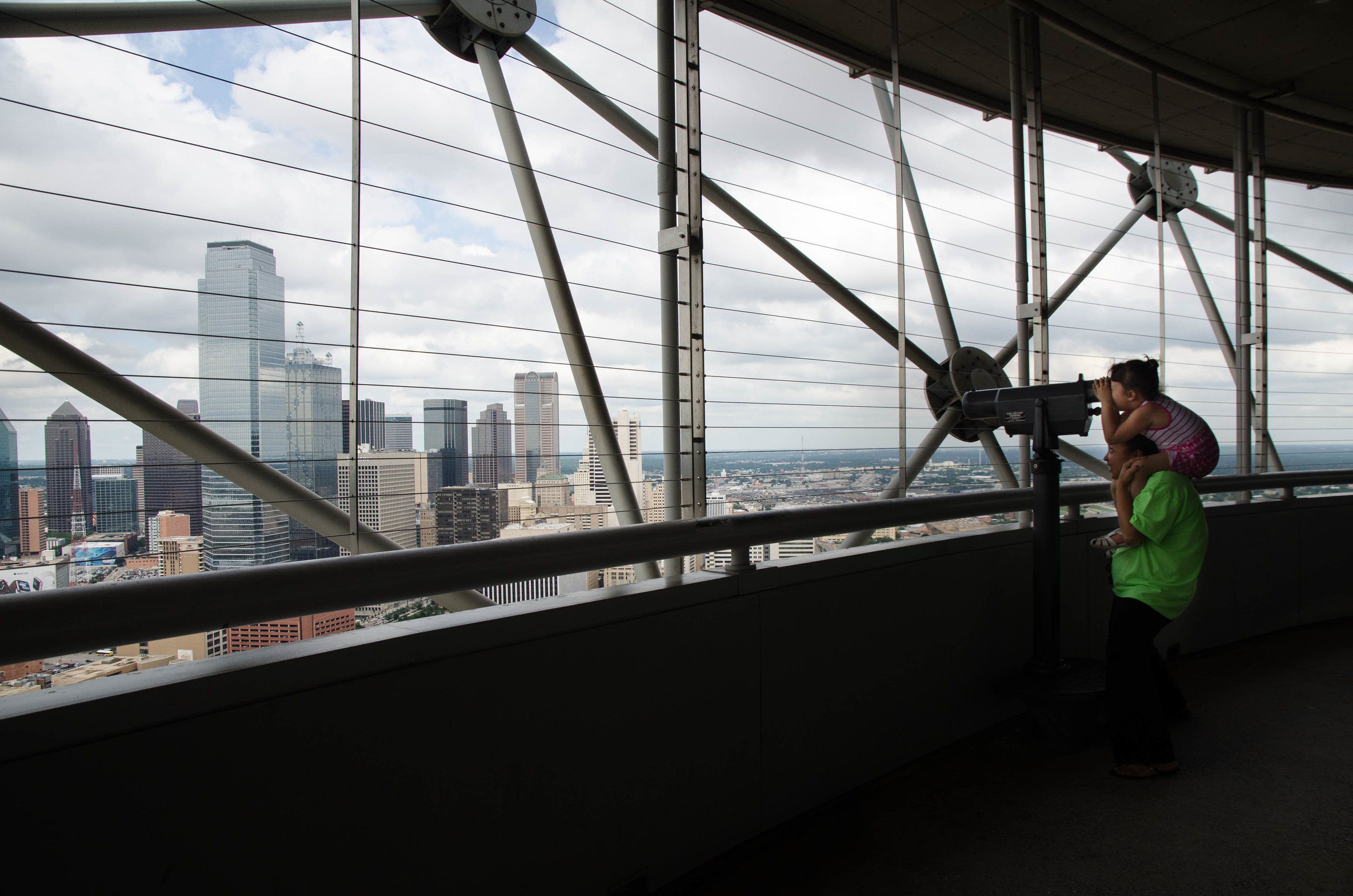  A young girl sits on her mother's shoulders to look at the view from Reunion Tower in Dallas, Texas. 