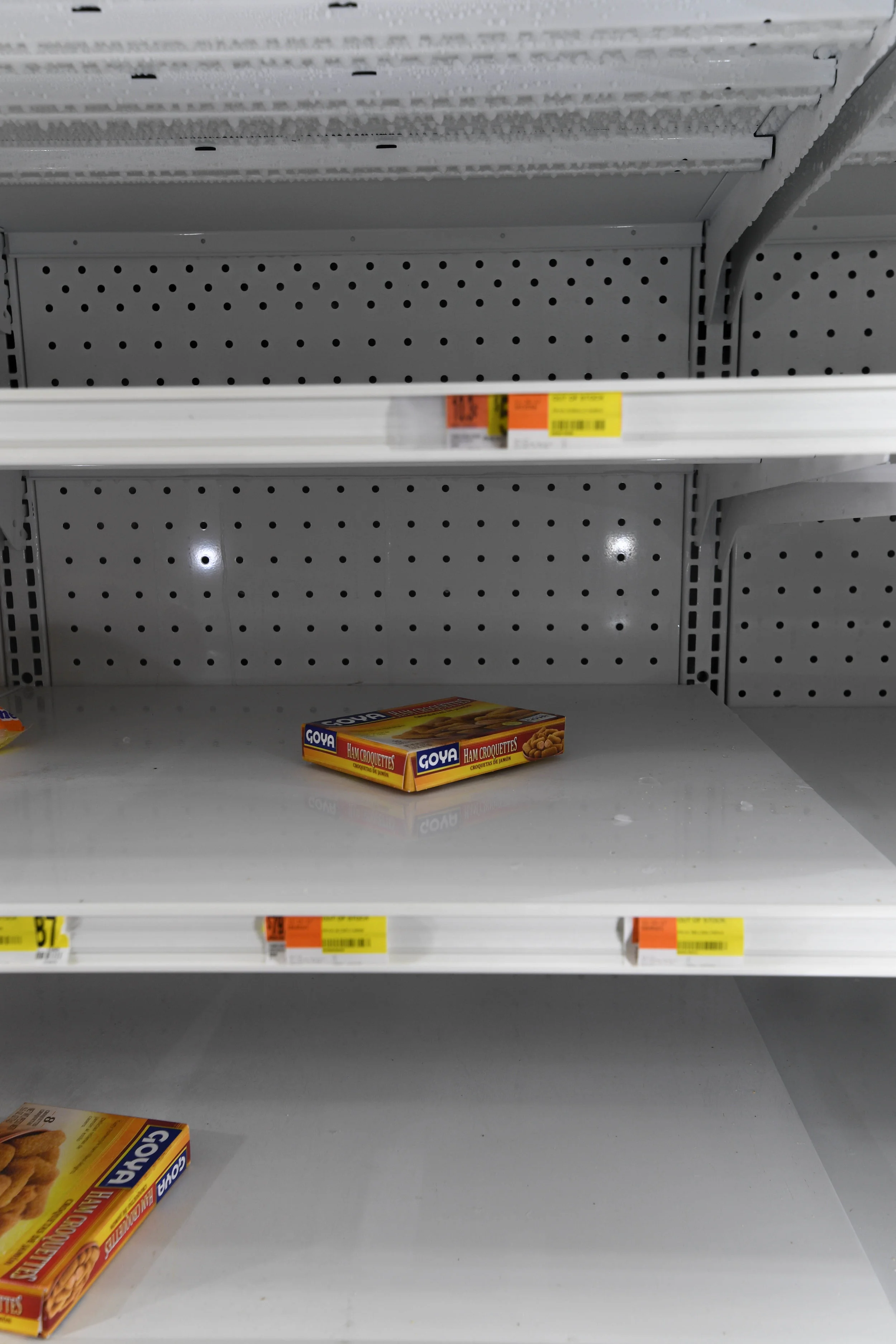 A freezer in Moca is nearly empty, with just three boxed of food left. Many grocery stores remain without power; the few running on generators cannot restock fast enough.