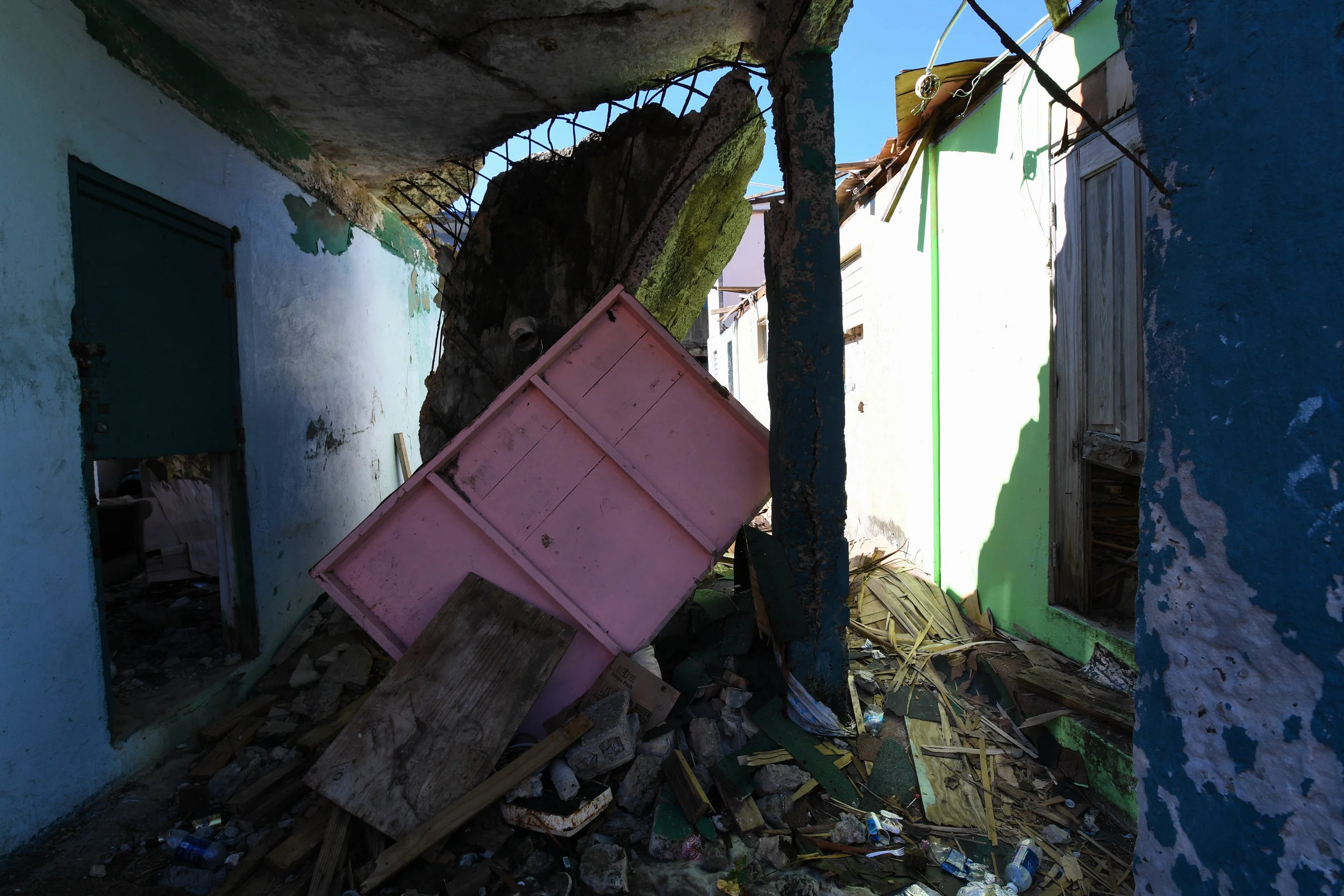 Parts of homes and concrete hang in an alley in La Perla.