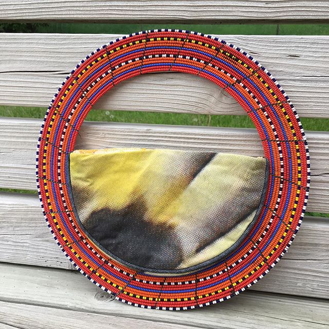 This African Necklace Handbag is a statement piece! An authentic African necklace sets up the framework for this little beauty. The lining is made from a vintage silk table cloth and my own fabric is the exterior. There&rsquo;s an inner pocket and a 