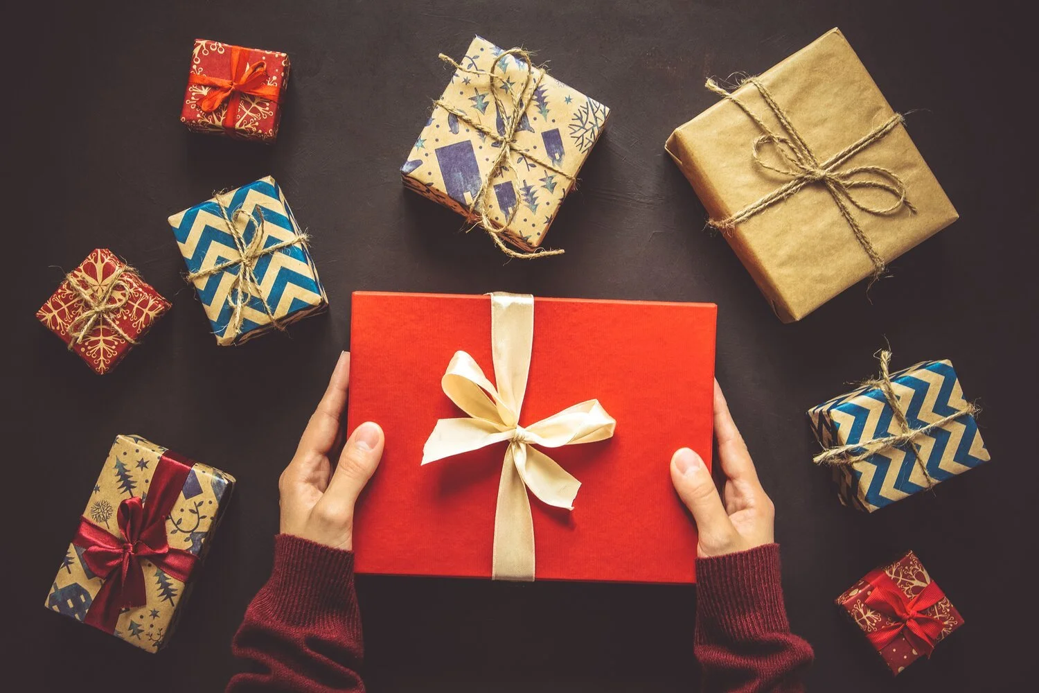 womens-hands-holding-gift-box-present-boxes-background-top-view-flat-lay-toned-image_t20_ko011K.jpg