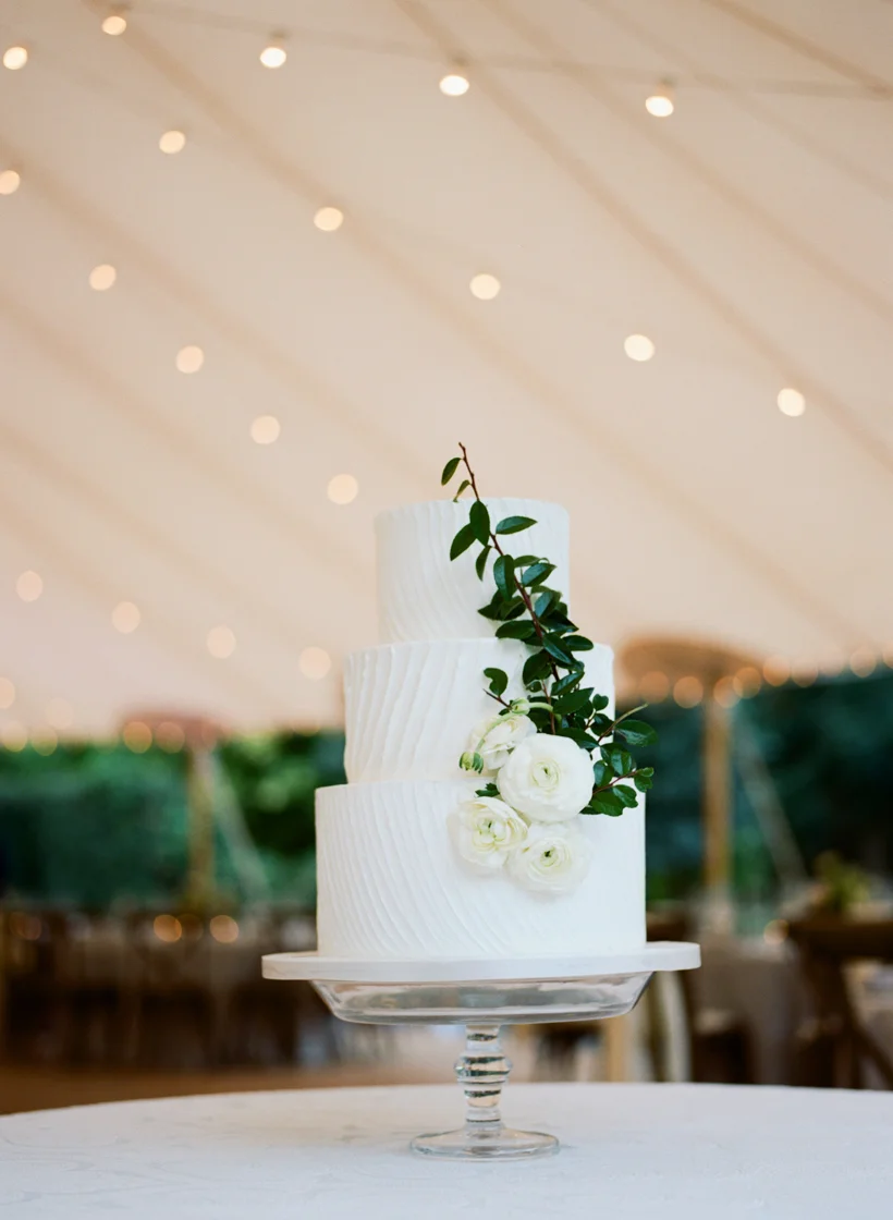 Wedding Cake from Earth and Sugar accented by ranunculus and greenery. Photo by Kat Braman.