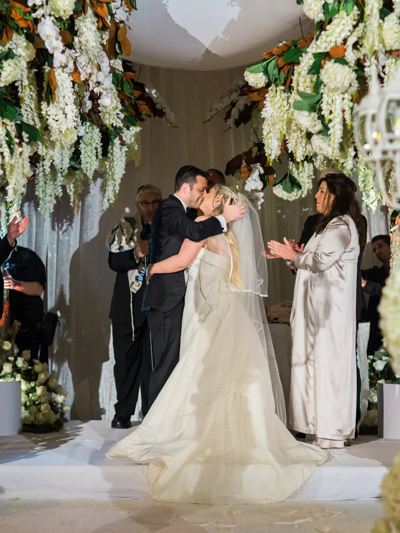 First kiss at Mar-a-Lago Club wedding in Palm Beach, Florida. Photo by Kat Braman