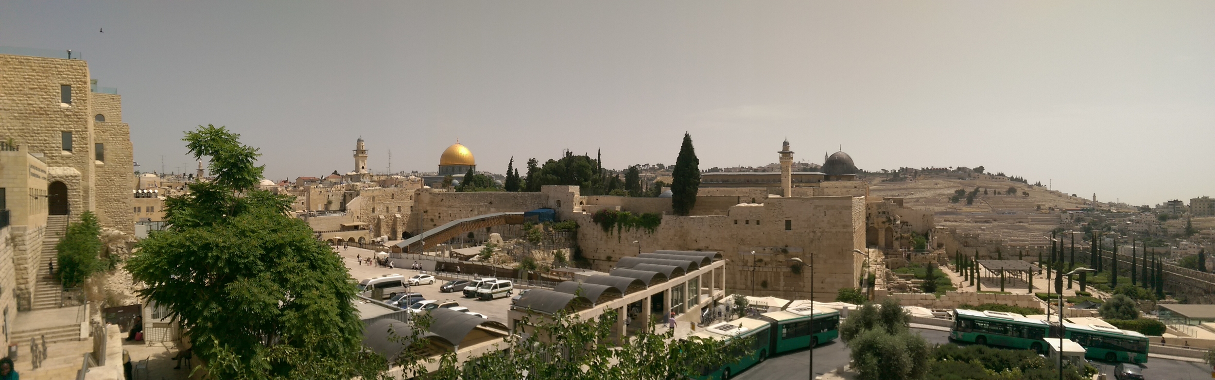 Glimpse of the Temple Mount, with the Dome of the Rock (gold) and the Western Wall in front of that.