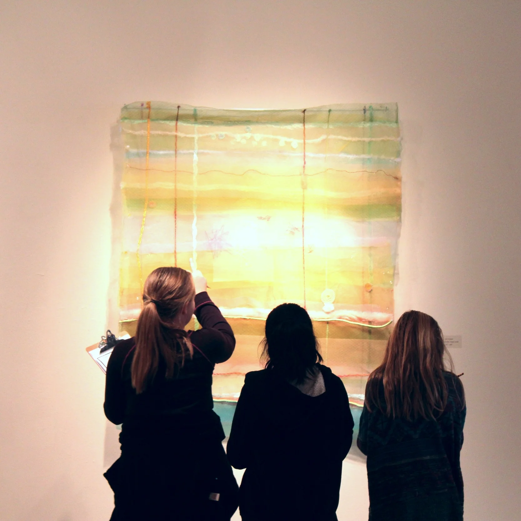 Denton ISD students discuss the work of artist Cathy Breslaw, developing their own interpretations using creative writing and sketching in the galleries.