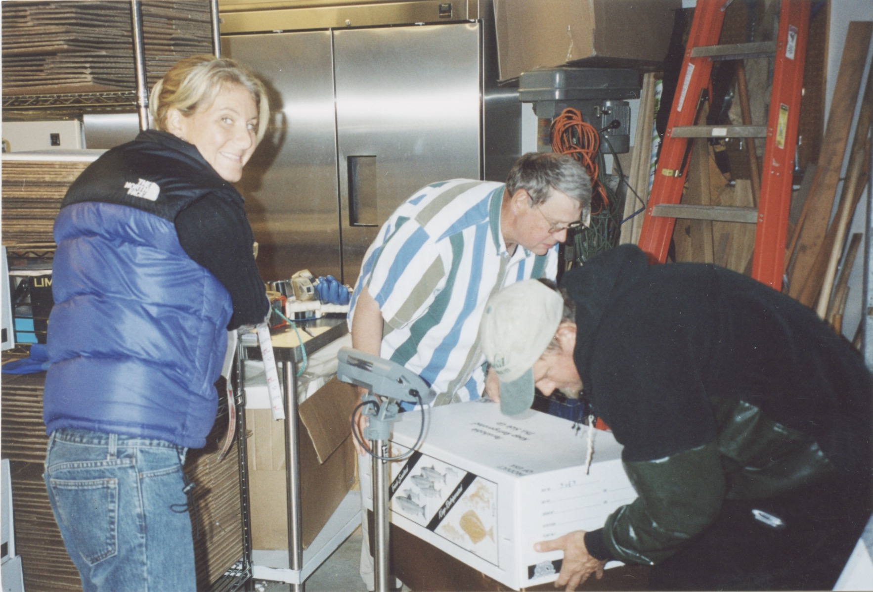 Pete, Heather and Heather's husband, Kirk, packing fish boxes in the family garage in 2003, the first summer Taku River Reds shipped salmon to customers in the "Lower 48."