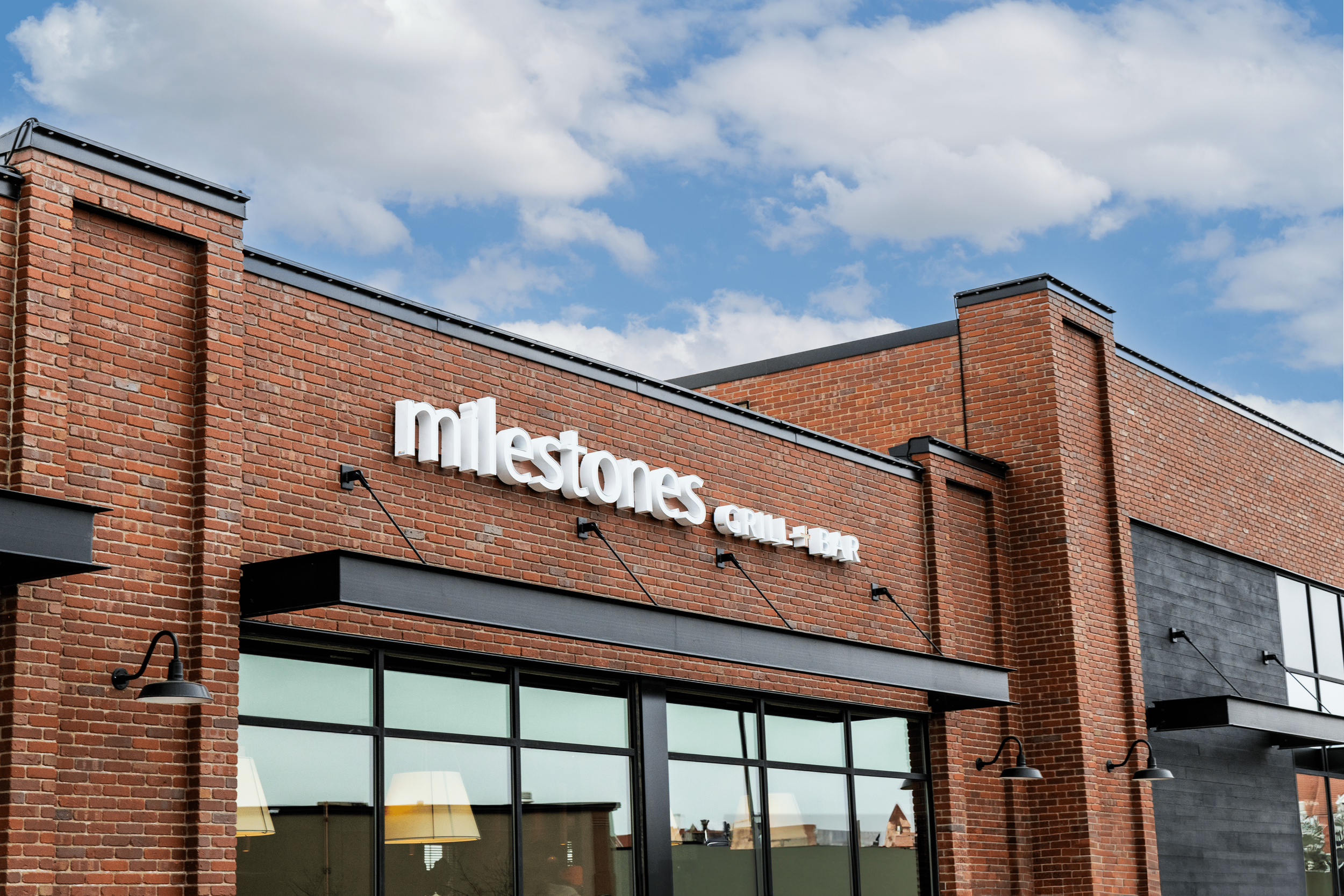 Milestones - storefront sign angle-min.png