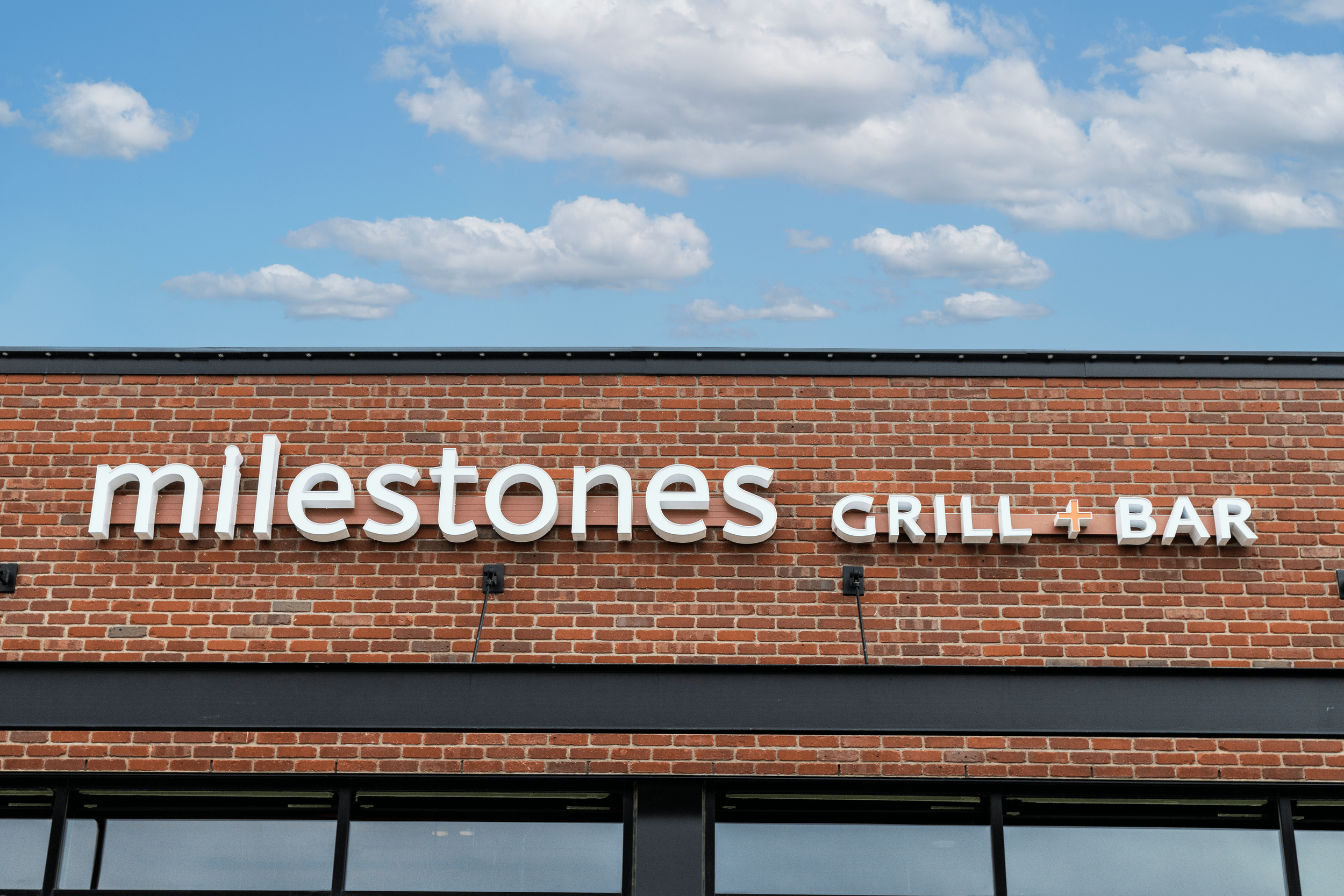 Milestones - storefront sign-min.png