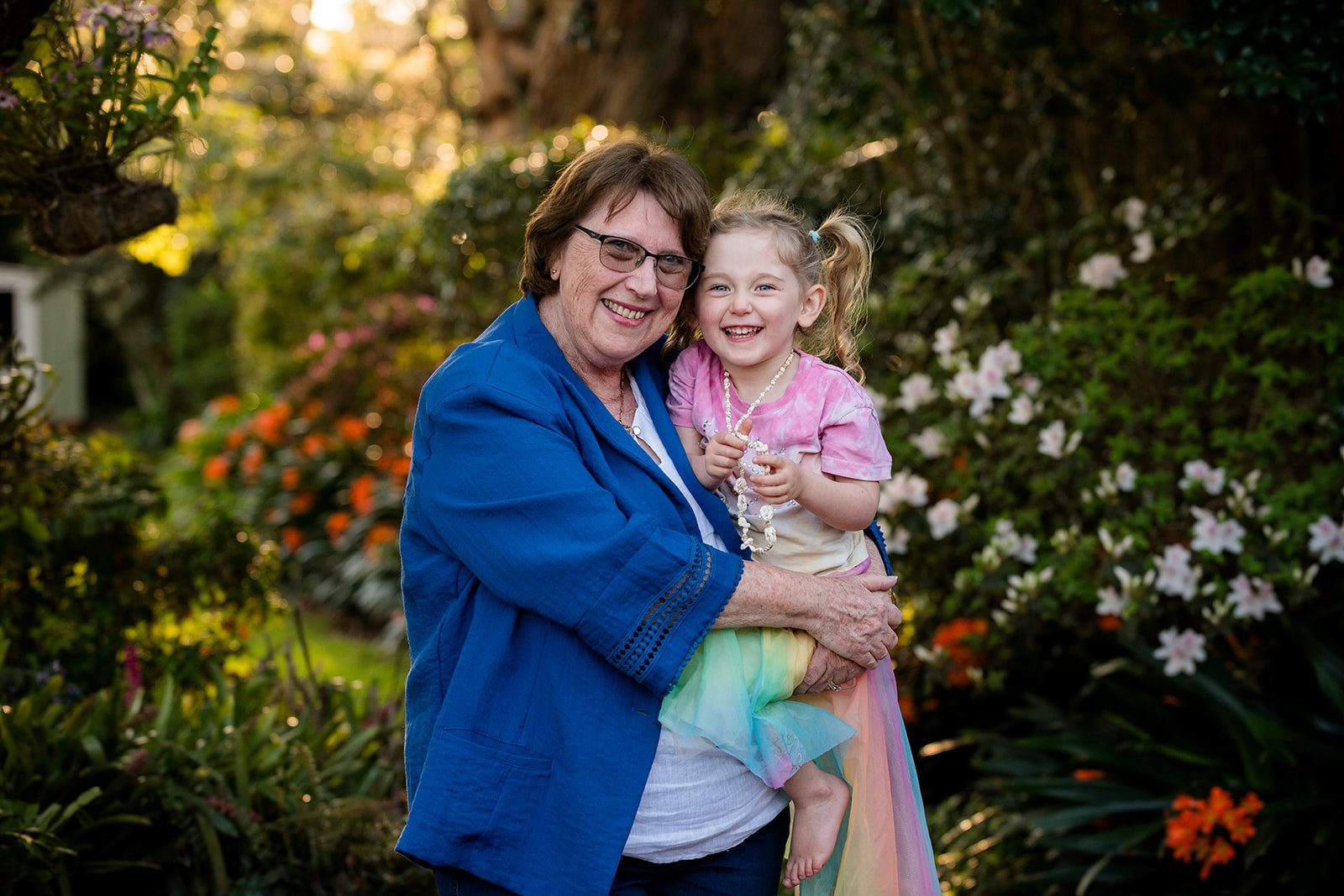 Grand mother and her grand daughter giggling at the the camera