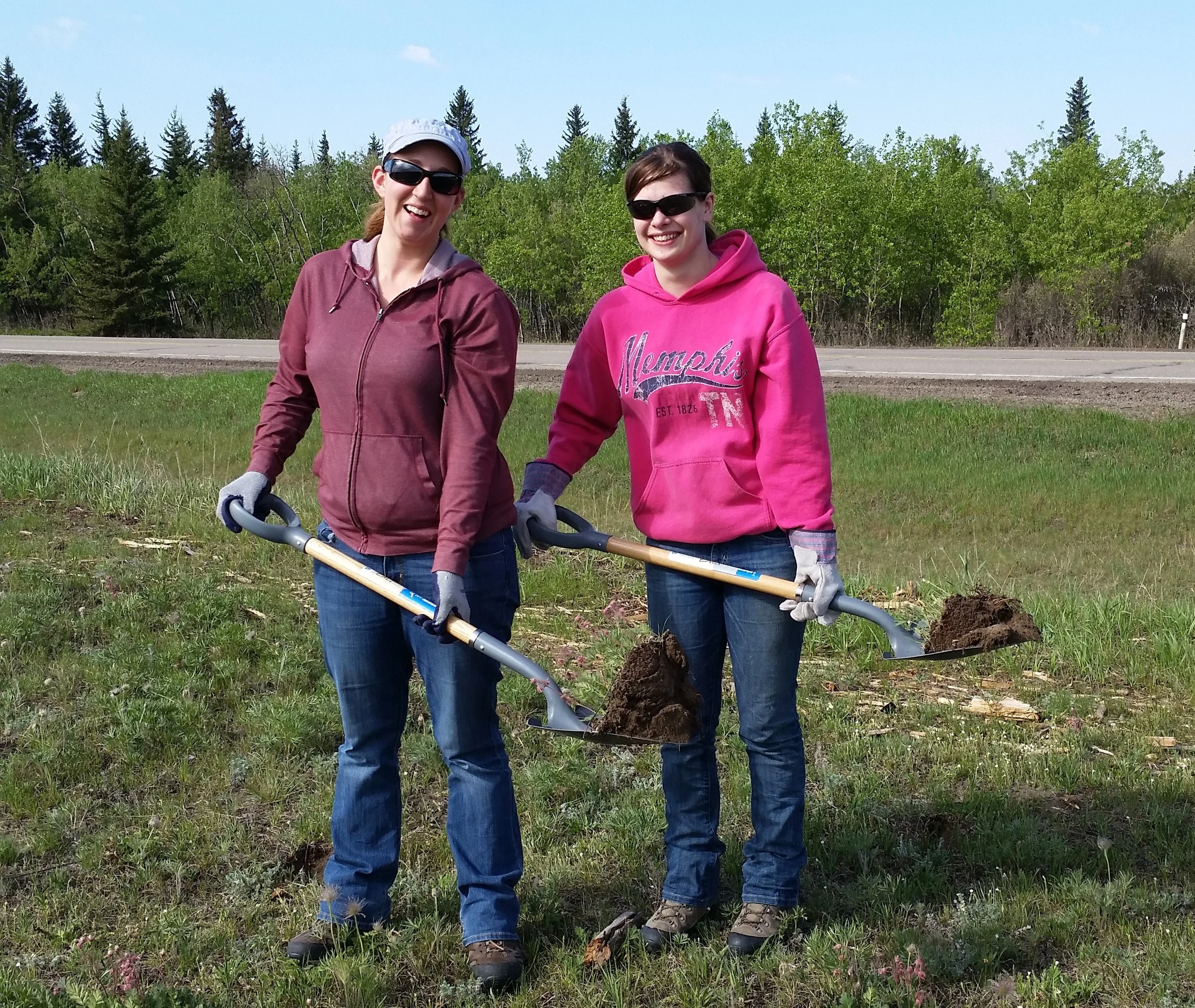 Rebecca and Felysia with their shovels filled with native plants!