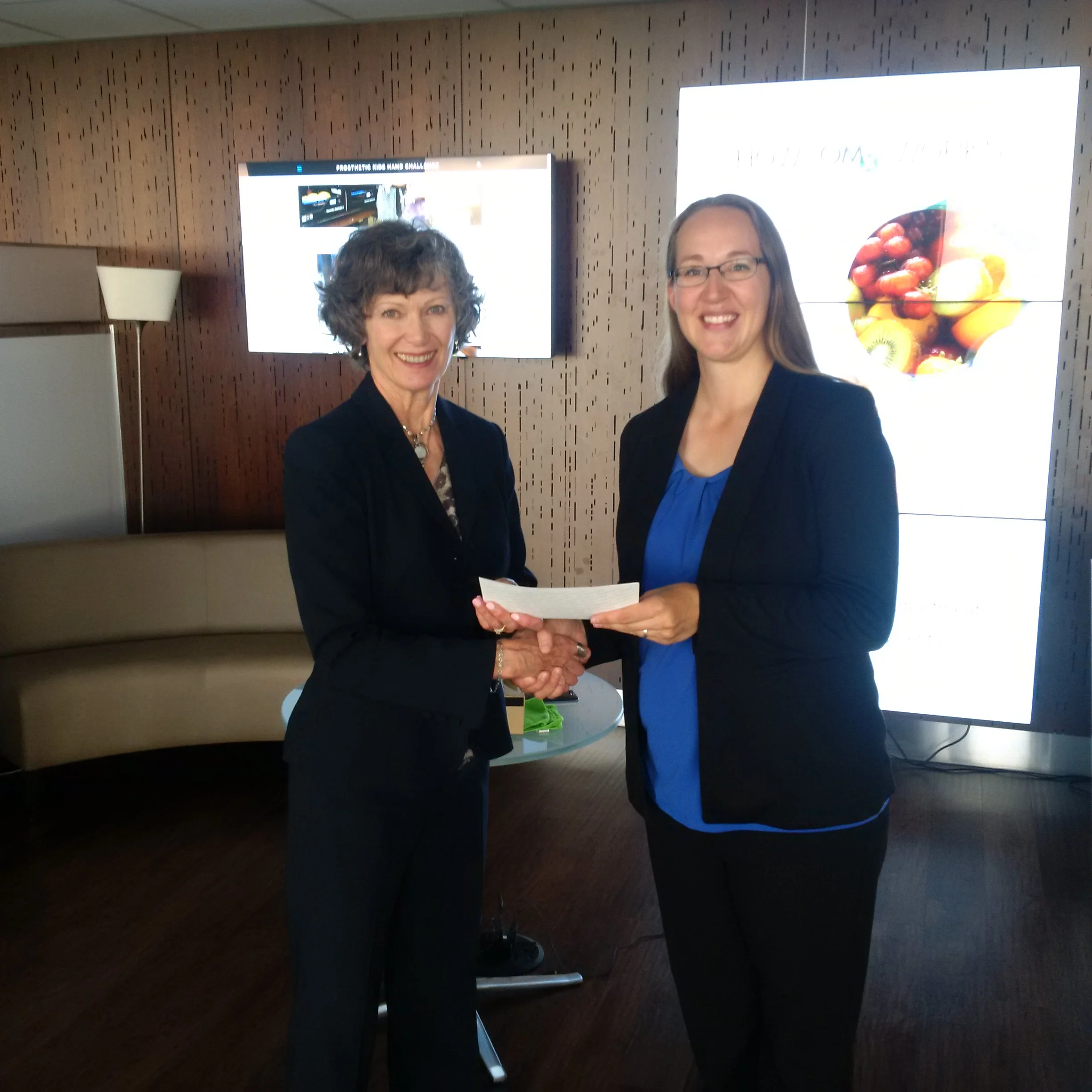 EALT receiving a cheque from Telus Community Board member Ruth Collins-Nakai. Photo by Dan Campbell, Telus.