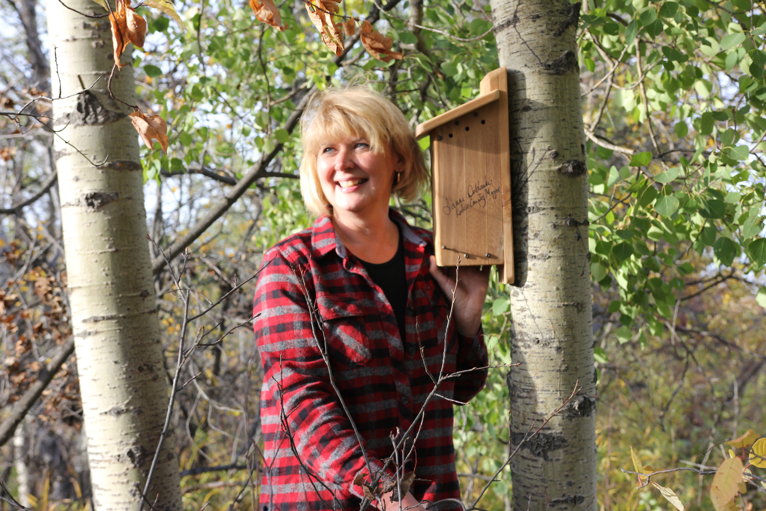 Mayor of Leduc County with the nest box she installed at Coates Conservation Lands