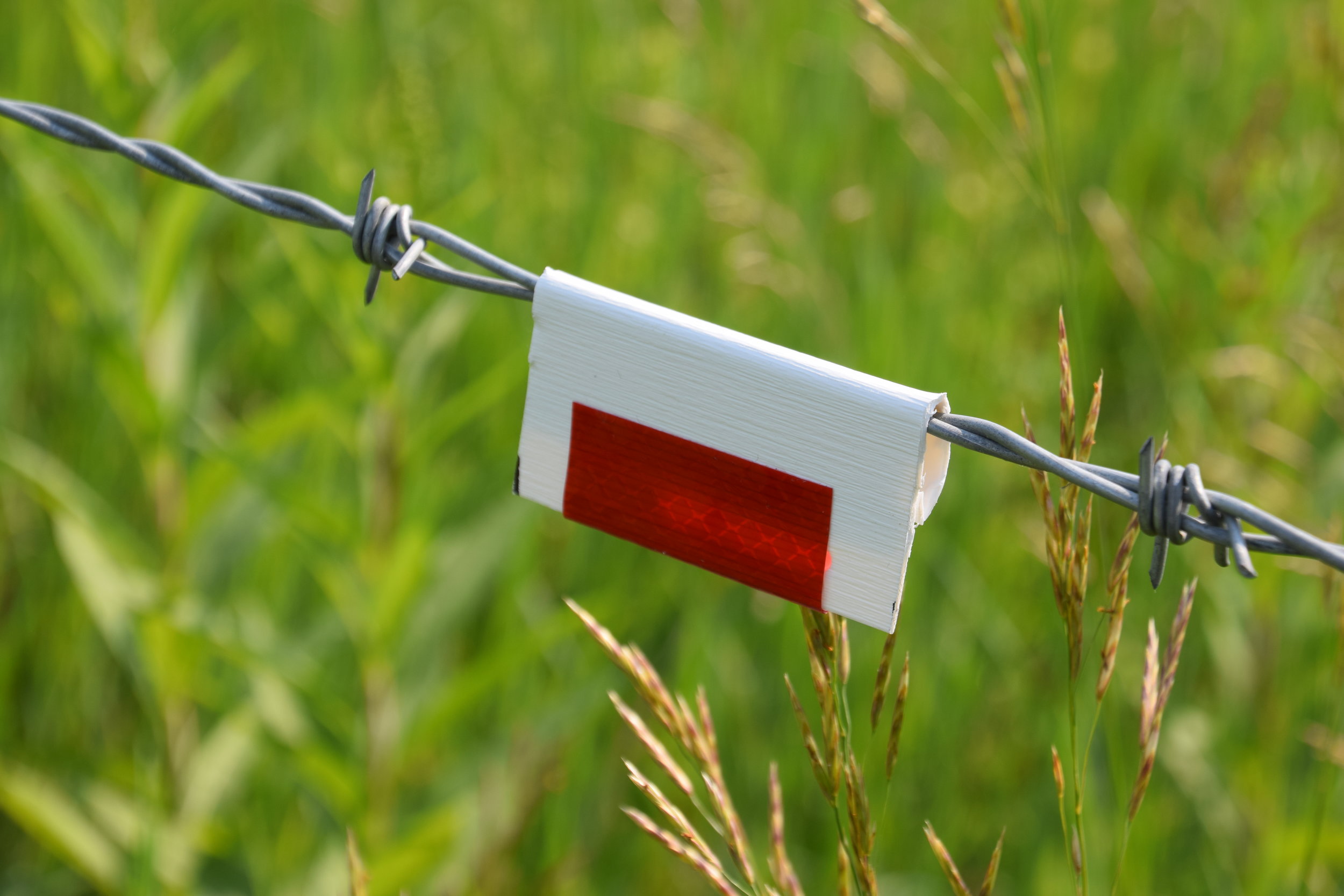 Simple reflectors on fences can increase visibility for wildlife.