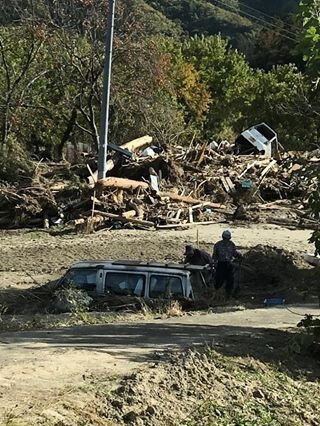 Rescuing tools from a car buried by mudslides.jpg