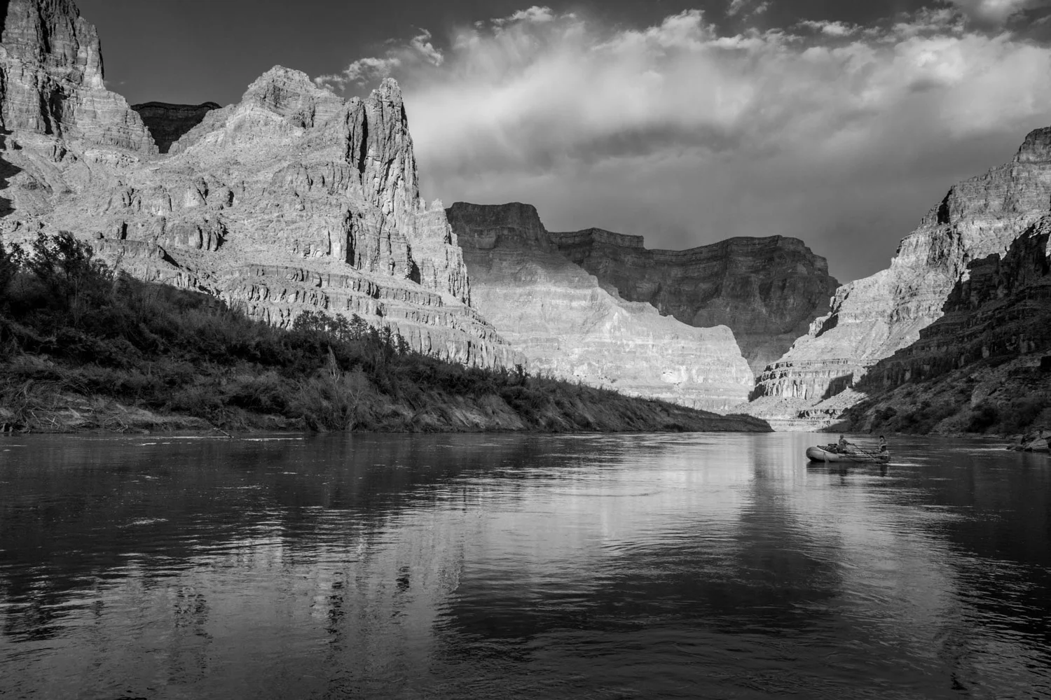 Black and White photograph B & W of Woman rowing raft below Grand Wash Cliffs, Grand Canyon, Arizona