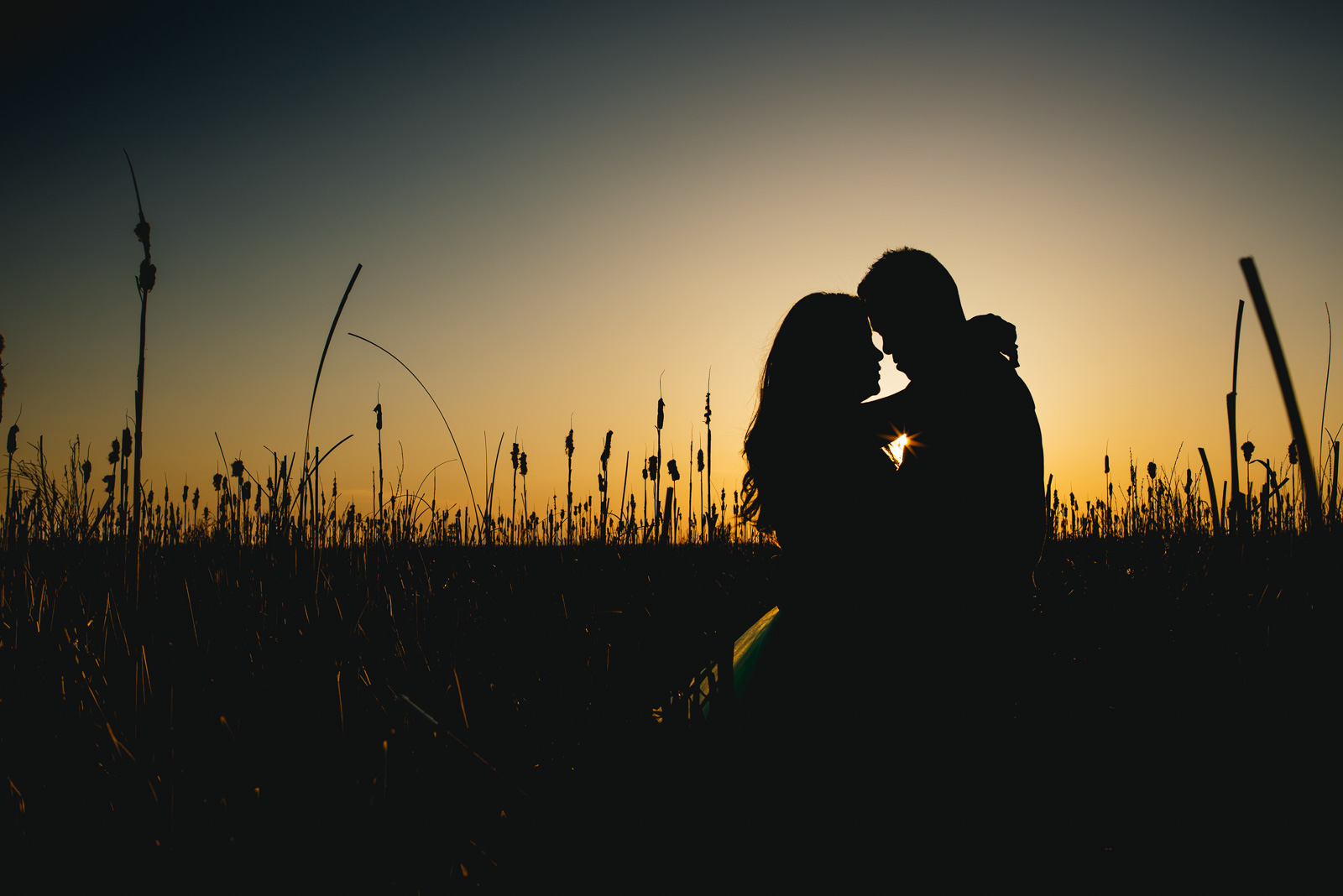   ^ I’m a total sucker for silhouettes, and this is one of my favourites that I’ve ever shot. &nbsp;I love the tones of the sky, the little hint of the sun popping between them, the reeds, the love in Jimmy &amp; Esther’s pose. &nbsp;Just perfect!  