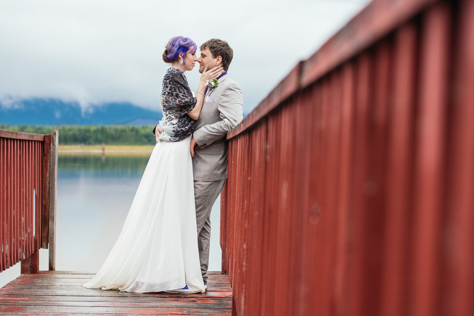   ^ This image from Travis &amp; Kaylee’s wedding has just about everything that we love at Pebble &amp; Pine! &nbsp;Mountains, trees, ocean, a rustic red dock, thick cloud cover, and a couple that’s crazy about each other. So glad that we found a li