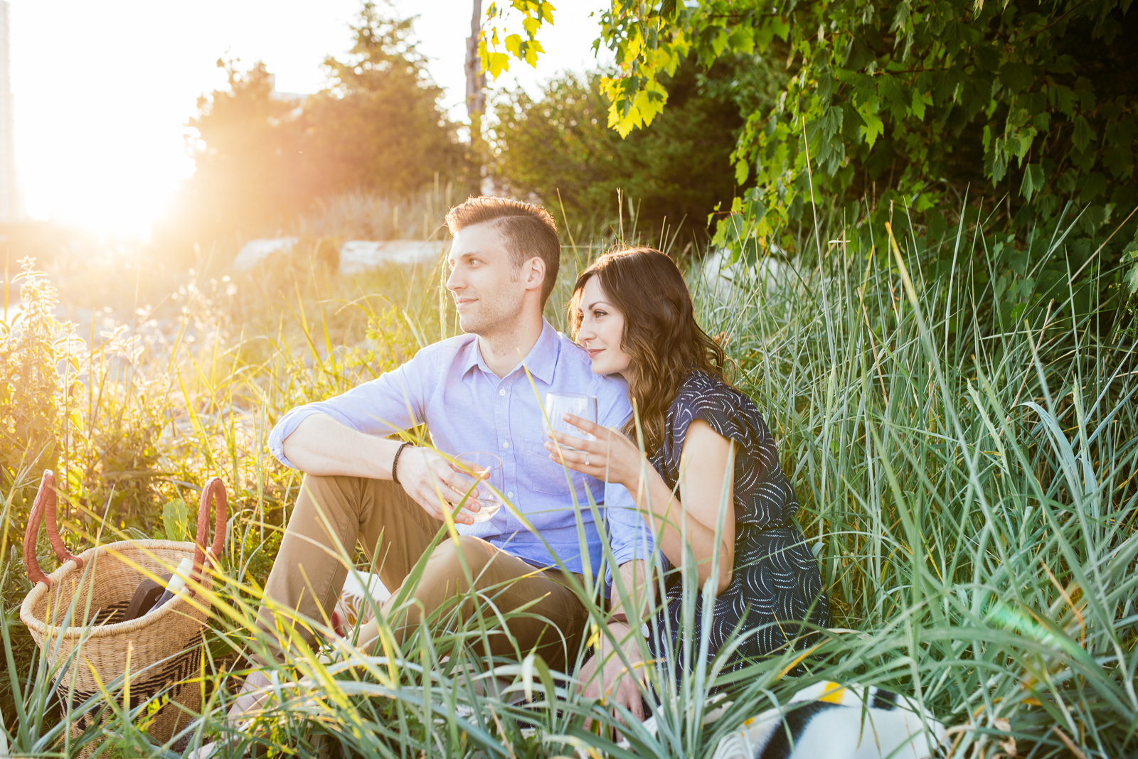   ^ As photographers, we are always chasing light! &nbsp;Searching out the best spots, yearning for that beautiful backlit sunset goodness. &nbsp;Darren and Lindsay’s picnic engagement shoot had a beautiful golden sunset that lit them up in pretty am