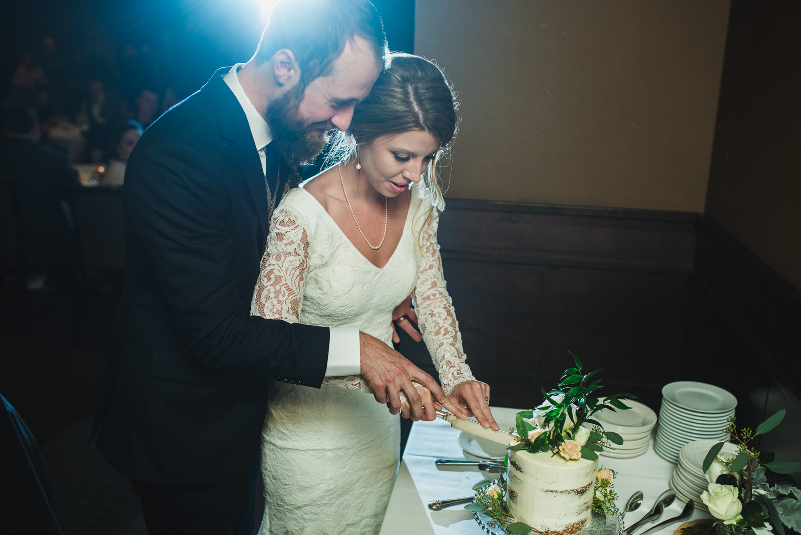 cutting the cake in the ballroom at nita lake lodge in whistler bc - victoria wedding photographers