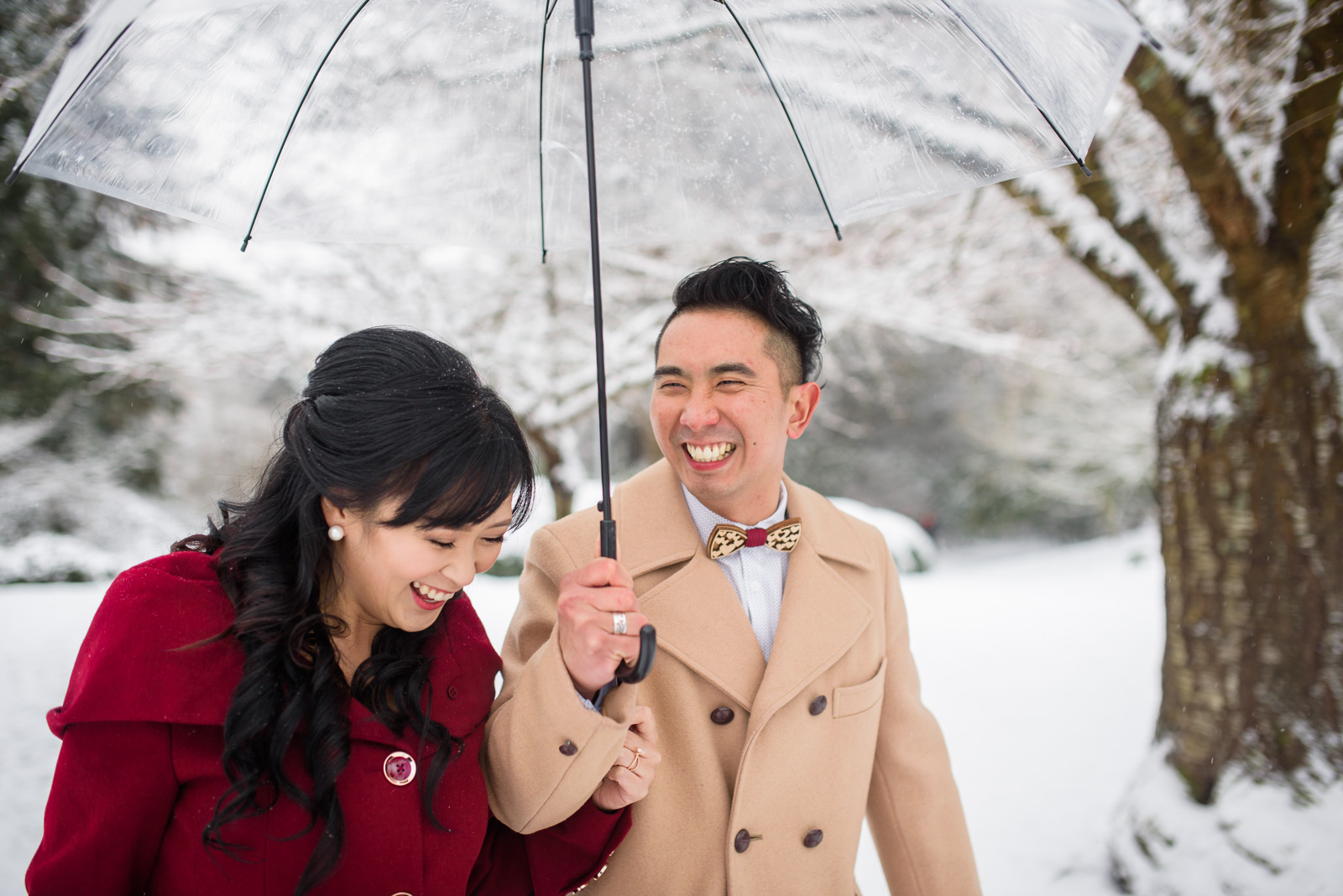 couple laughing in the snow at their wedding at at minoru chapel in richmond bc - victoria wedding photographers