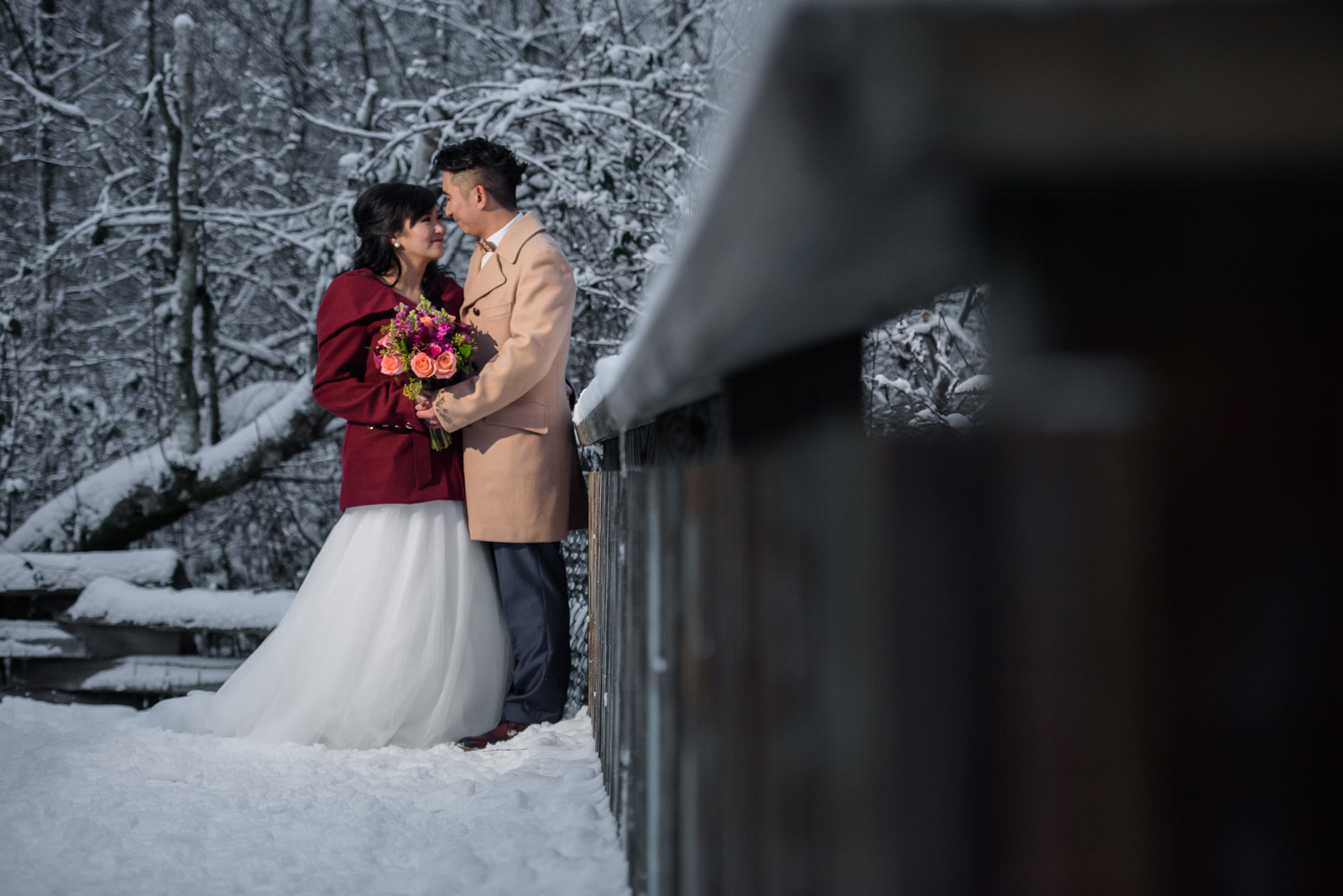 snowy wedding portrait on a bridge in richmond nature park - victoria wedding photographer