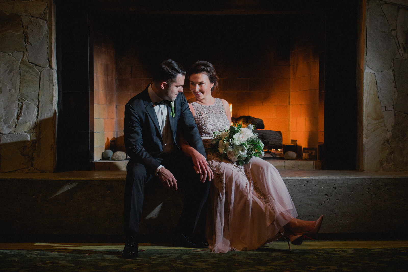 bride and groom portrait in front of the fireplace at Westwood Plateau - Vancouver Island Wedding Photographers