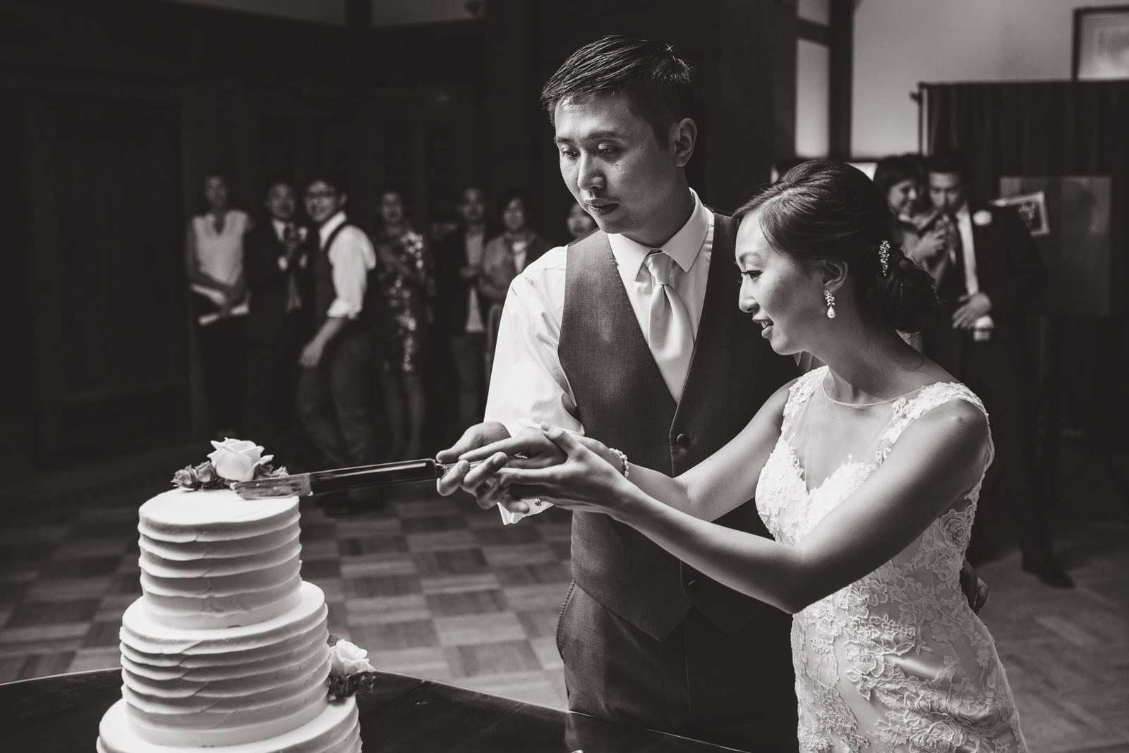 bride and groom cutting the cake at their wedding at cecil green park house on ubc campus in vancouver - victoria wedding photographers