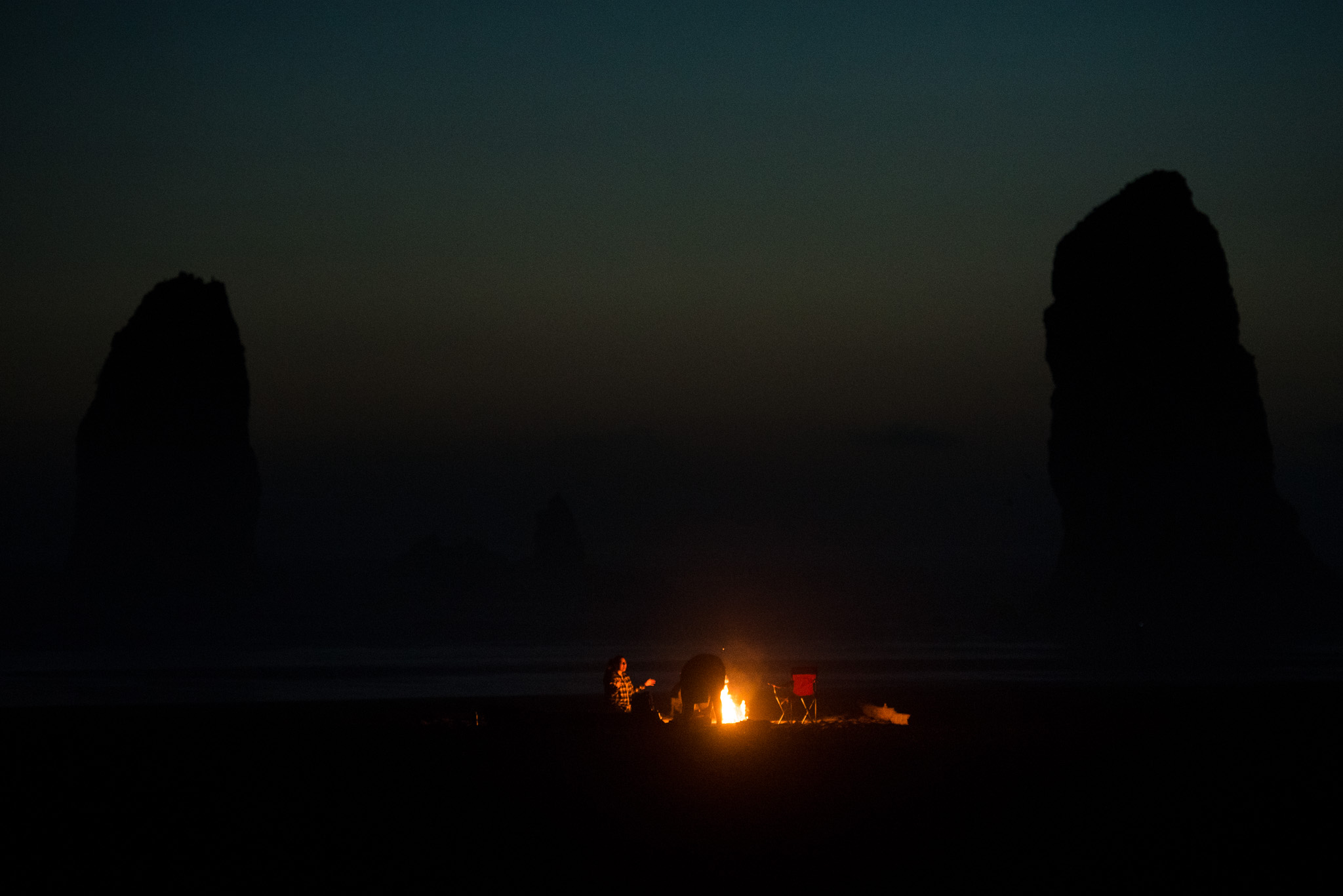  Campfires on the beach with the giant rock formations looming in the background.&nbsp; 
