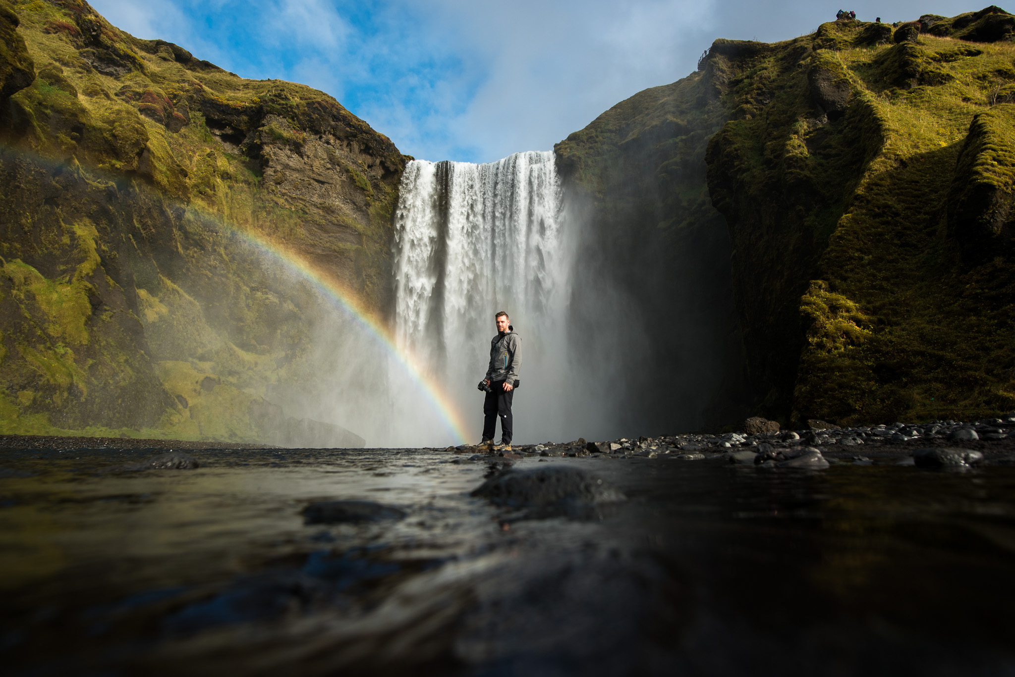 Matt at the end of a rainbow, at the bottom of Skogafoss.