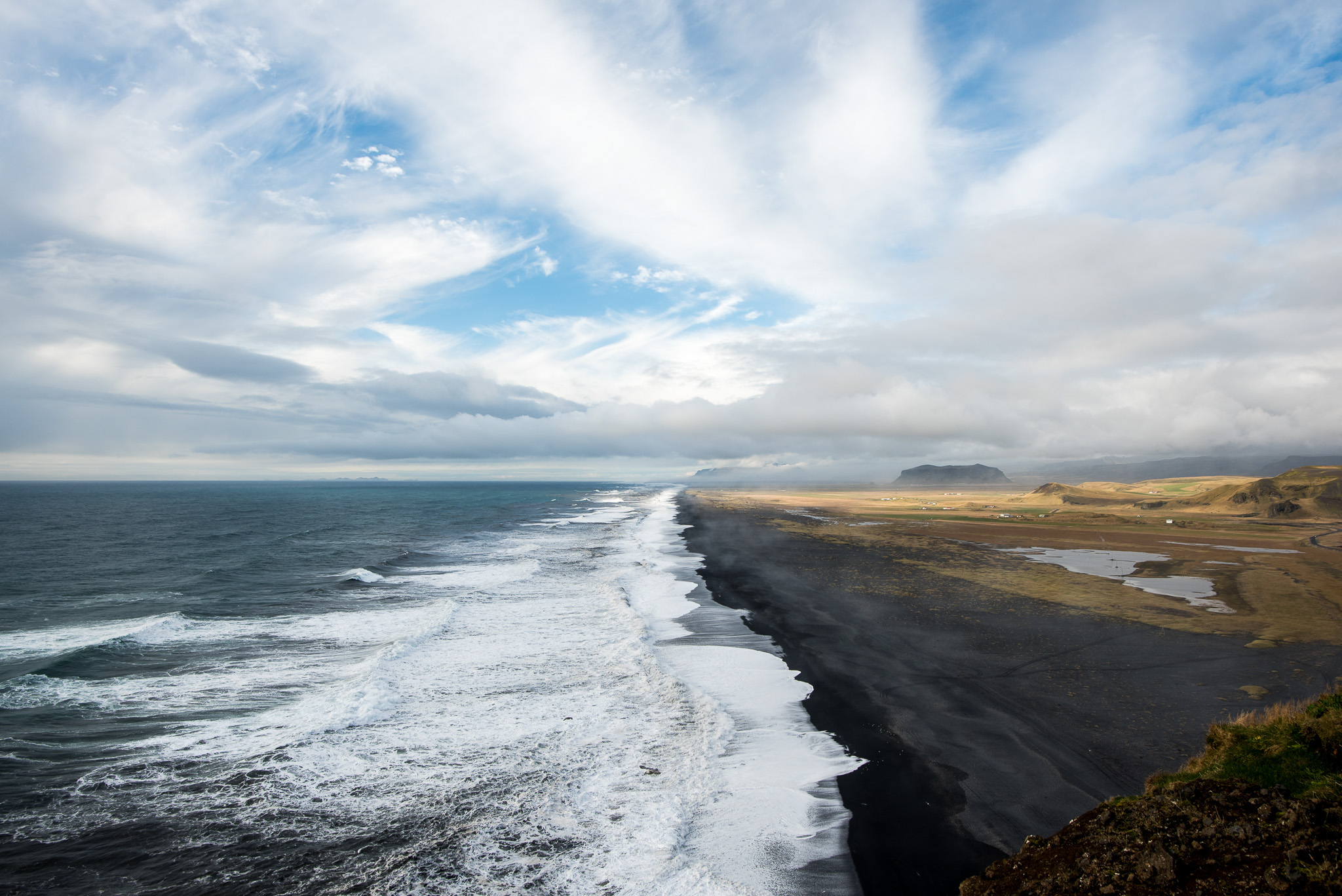 Overlooking expanses of black sand beach under the Dyrholaey cliffs.